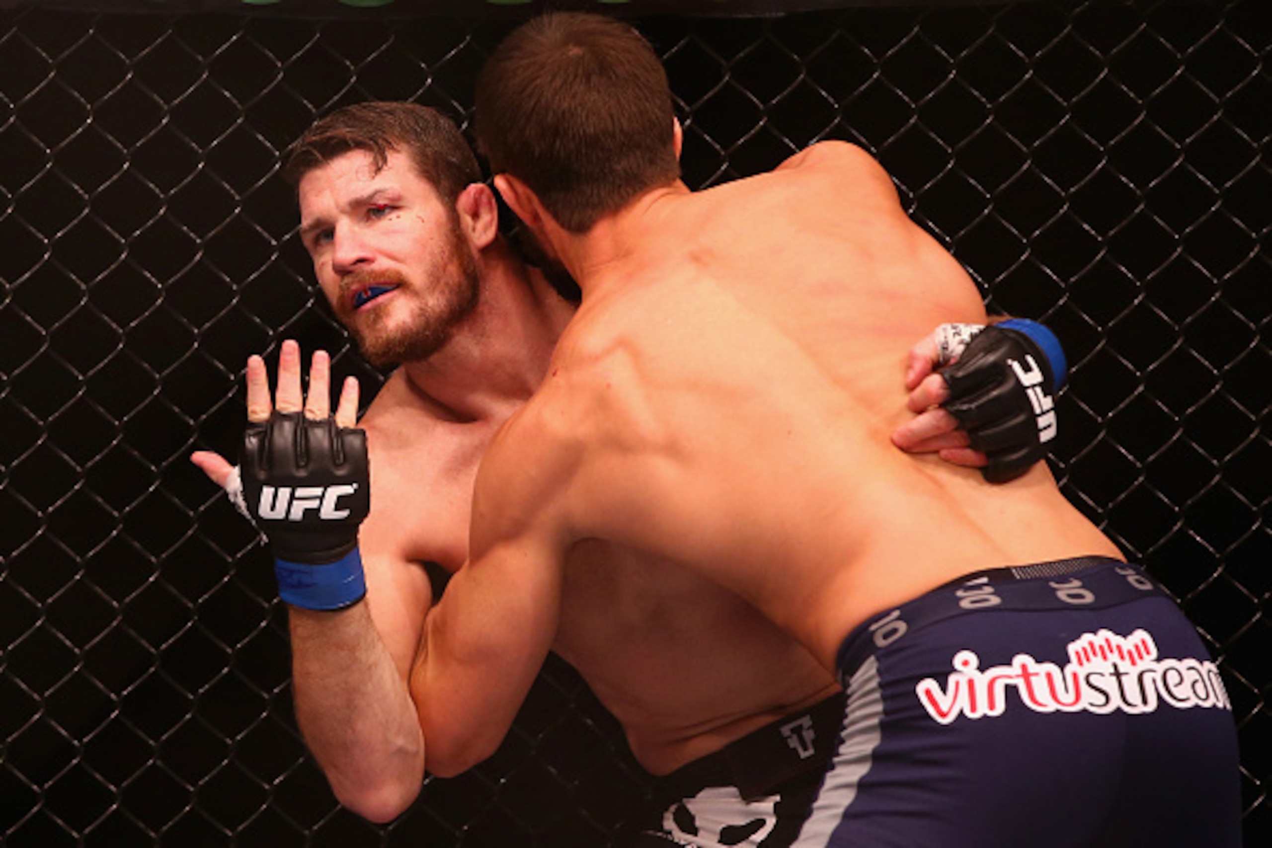 SYDNEY, AUSTRALIA - NOVEMBER 08:  Michael Bisping appeals to the referee after being cut above the eye by Luke Rockhold in their middleweight fight during the UFC Fight Night 55 event at Allphones Arena on November 8, 2014 in Sydney, Australia.  (Photo by