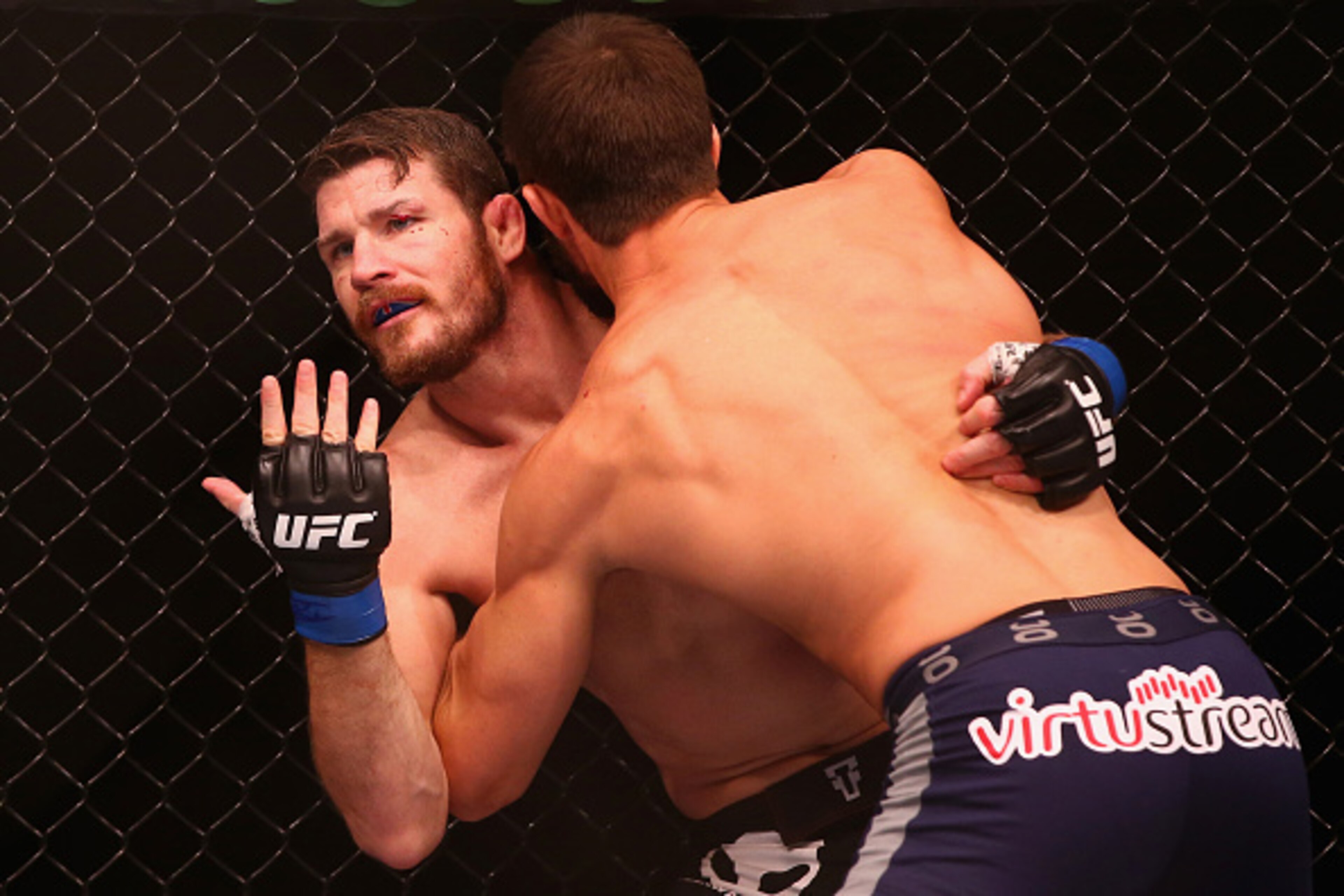 SYDNEY, AUSTRALIA - NOVEMBER 08:  Michael Bisping appeals to the referee after being cut above the eye by Luke Rockhold in their middleweight fight during the UFC Fight Night 55 event at Allphones Arena on November 8, 2014 in Sydney, Australia.  (Photo by