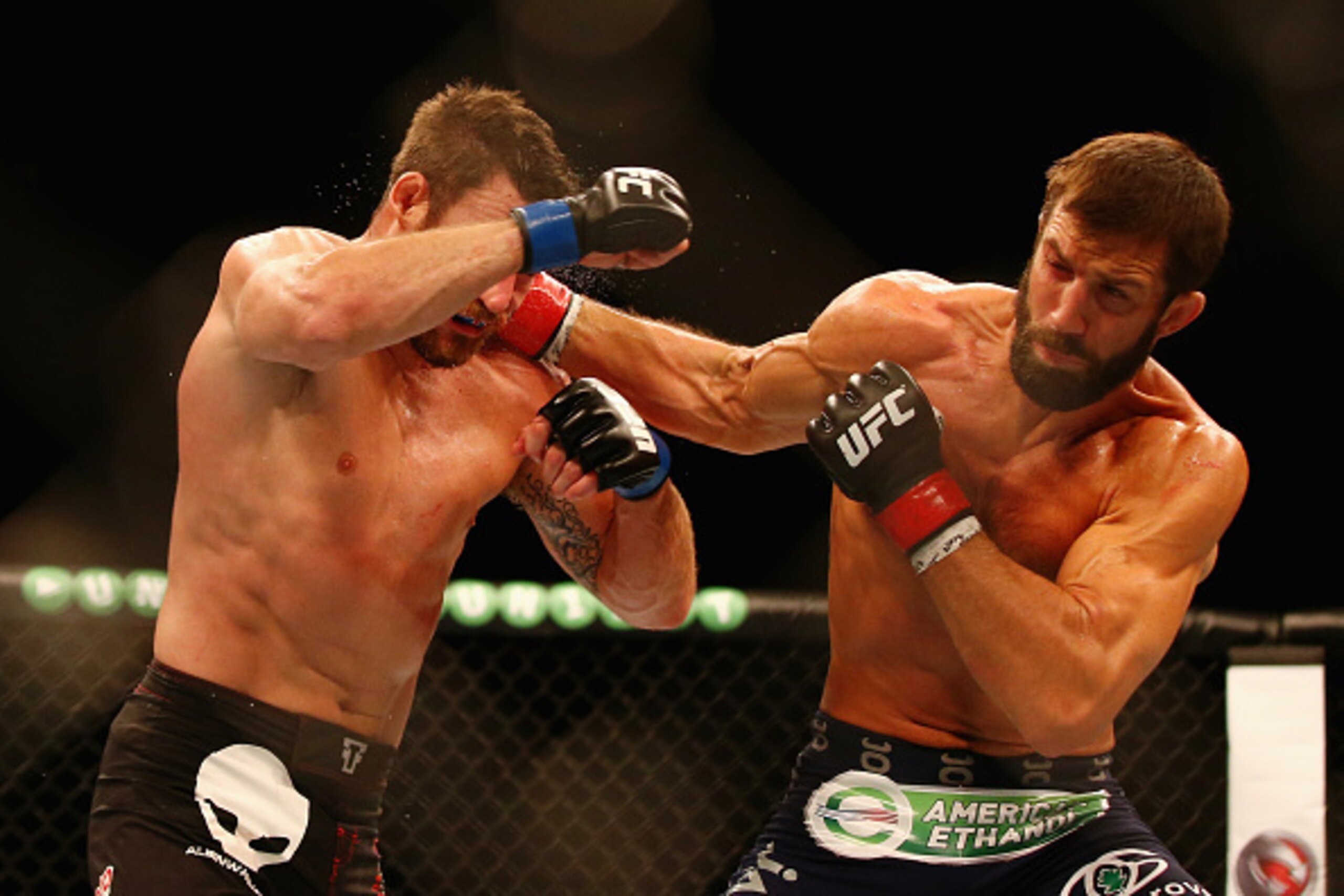 SYDNEY, AUSTRALIA - NOVEMBER 08:  Luke Rockhold of the USA (R) connects with a right to the face of Michael Bisping of England in their middleweight fight during the UFC Fight Night 55 event at Allphones Arena on November 8, 2014 in Sydney, Australia.  (P