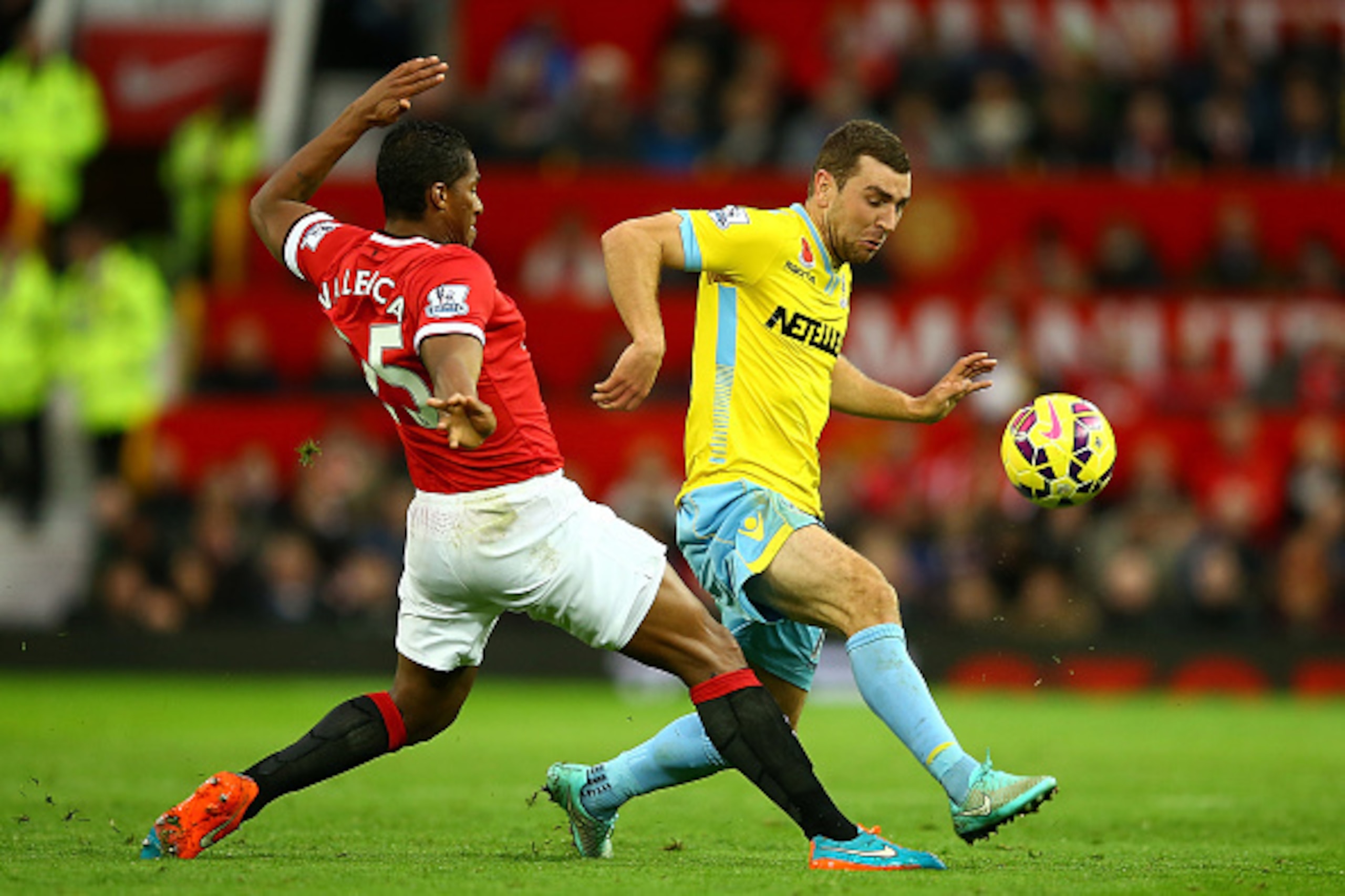 MANCHESTER, ENGLAND - NOVEMBER 08:  Antonio Valencia of Manchester United challenges James McArthur of Crystal Palace during the Barclays Premier League match between Manchester United and Crystal Palace at Old Trafford on November 8, 2014 in Manchester, 