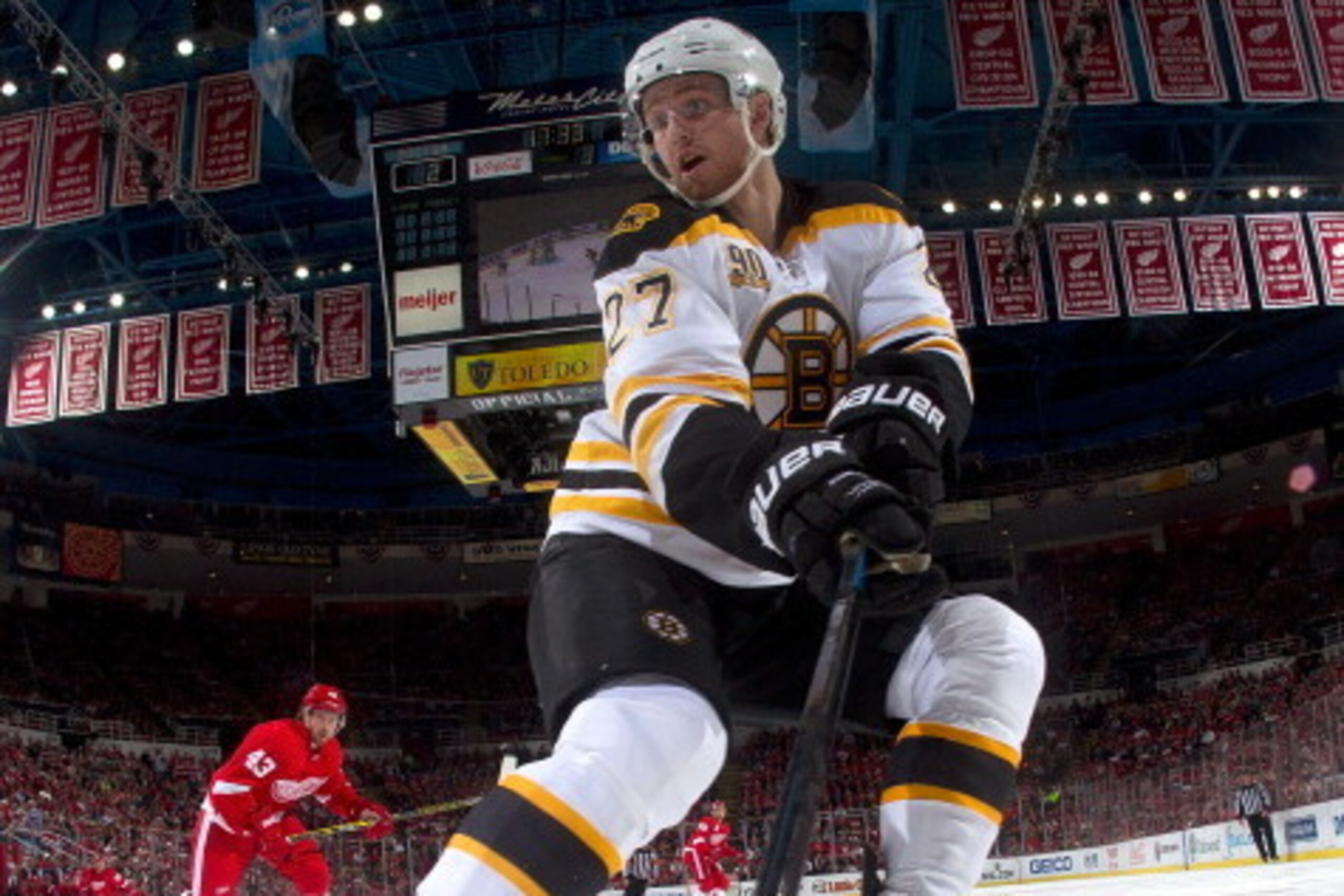 DETROIT, MI - APRIL 24:  Dougie Hamilton #27 of the Boston Bruins grabs the puck off the boards as Darren Helm #43 of the Detroit Red Wings pressures him during Game Four of the First Round of the 2014 Stanley Cup Playoffs on April 24, 2014 at Joe Louis A