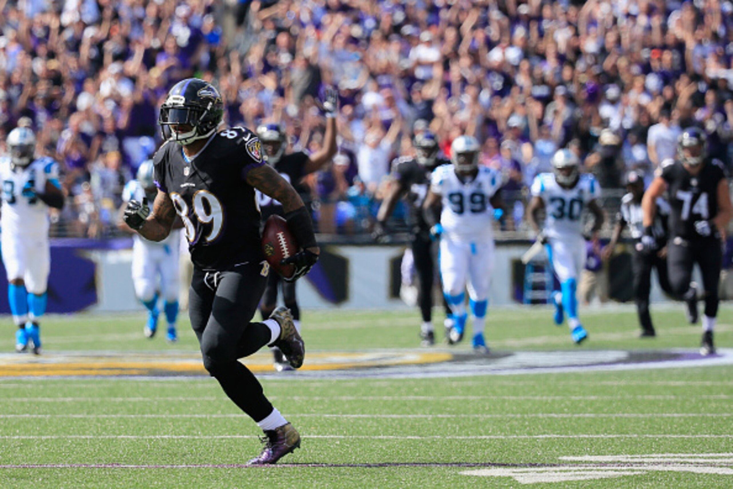 BALTIMORE, MD - SEPTEMBER 28:  Wide receiver Steve Smith #89 of the Baltimore Ravens carries the ball into the endzone for a touchdown after catching a pass in the first half against the Carolina Panthers  at M&T Bank Stadium on September 28, 2014 in Balt