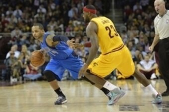 Oct 17, 2014; Cleveland, OH, USA; Dallas Mavericks guard Jameer Nelson (14) drives against Cleveland Cavaliers forward LeBron James (23) in the second quarter at Quicken Loans Arena. Mandatory Credit: David Richard-USA TODAY Sports