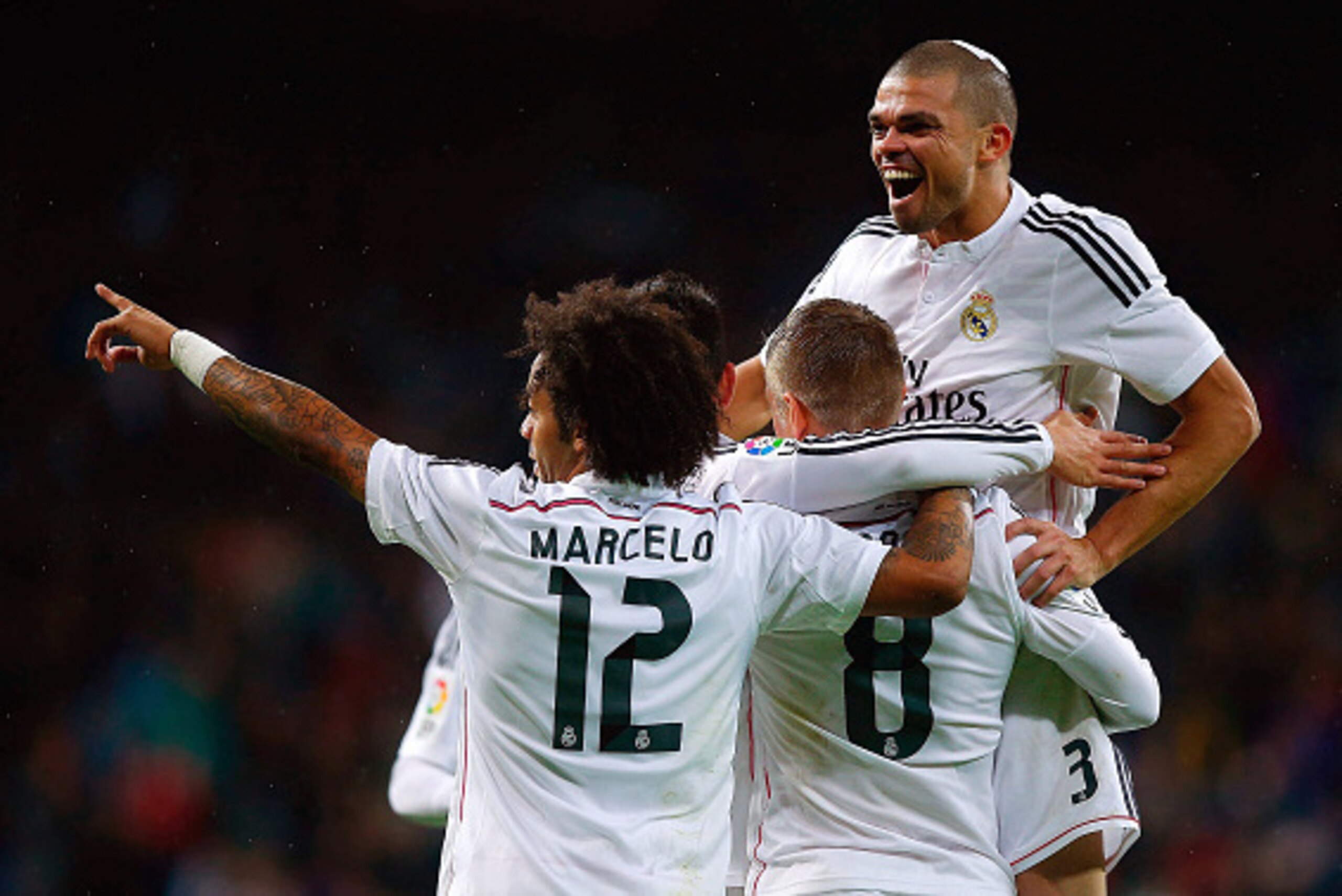 MADRID, SPAIN - NOVEMBER 08: Toni Kroos (2ndR) celebrates scoring their third goal with teammates Pepe (R) and Marcelo (L) during the La Liga match between Real Madrid CF and Rayo Vallecano de Madrid at Estadio Santiago Bernabeu on November 8, 2014 in Mad