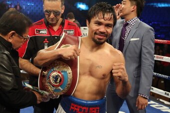 LAS VEGAS, NV - APRIL 12:  Manny Pacquiao celebrates his victory over Timothy Bradley at the MGM Grand Garden Arena on April 12, 2014 in Las Vegas, Nevada.  (Photo by Jeff Gross/Getty Images)