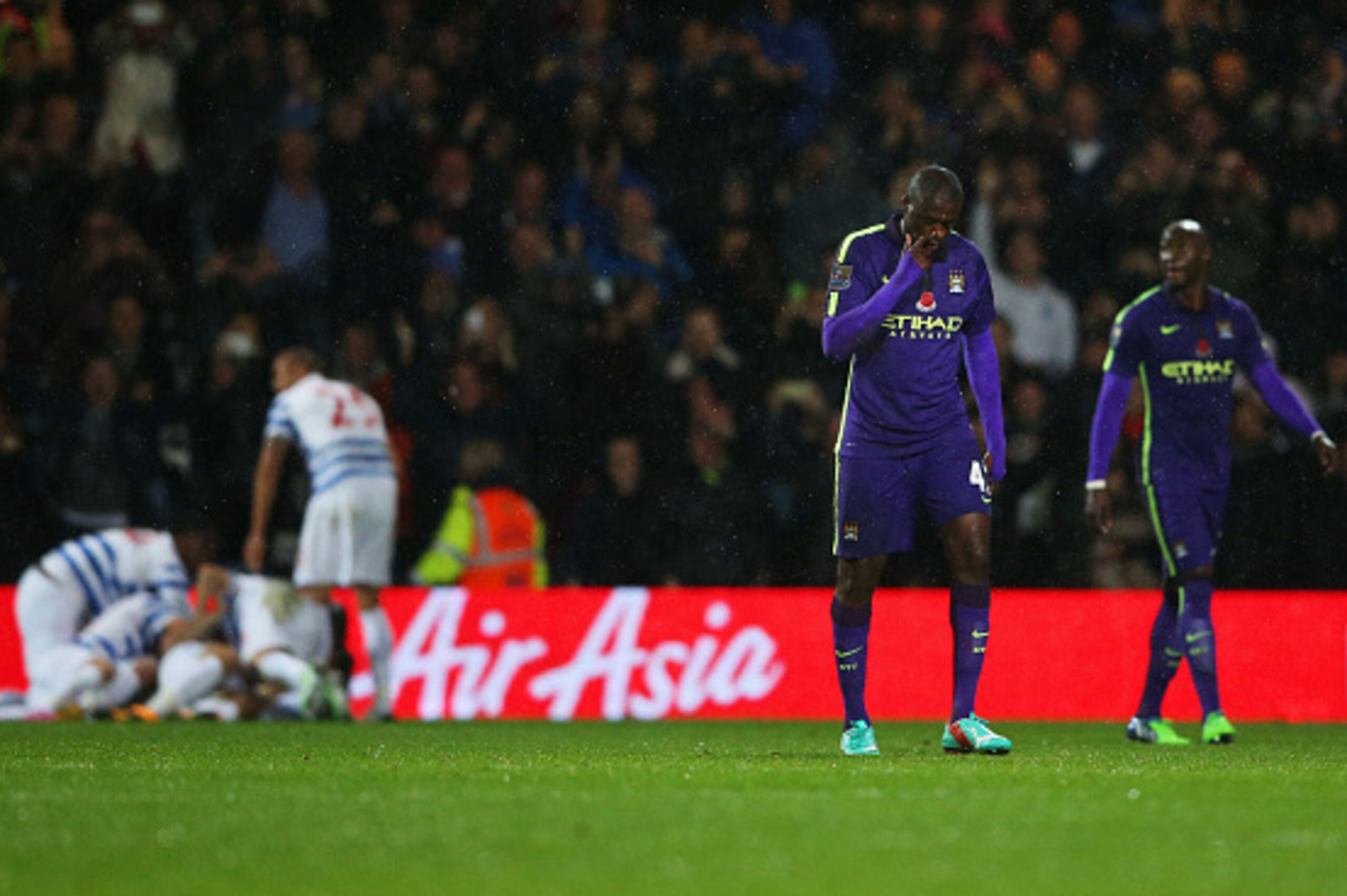 LONDON, ENGLAND - NOVEMBER 08:  Despair for Yaya Toure (2R) and Eliaquim Mangala of Manchester City as Charlie Austin of QPR scores their first goal during the Barclays Premier League match between Queens Park Rangers and Manchester City at Loftus Road on