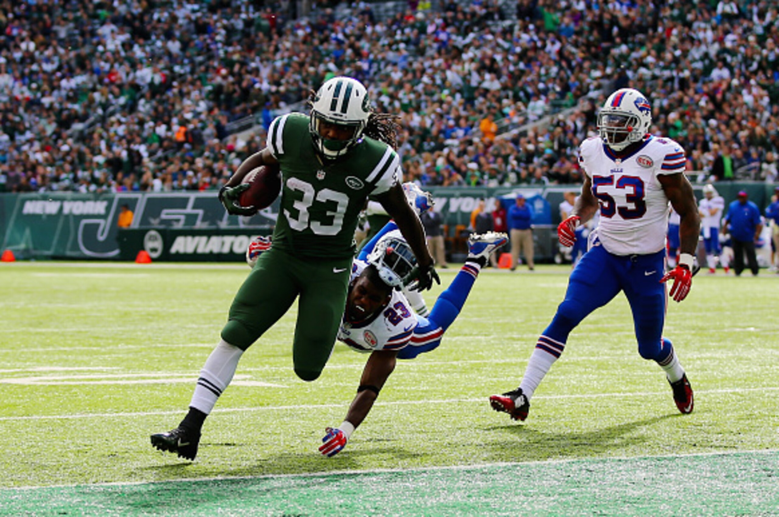 EAST RUTHERFORD, NJ - OCTOBER 26:  Chris Ivory #33 of the New York Jets scores a touchdown against Aaron Williams #23 of the Buffalo Bills and  Nigel Bradham #53 in the second quarter at MetLife Stadium on October 26, 2014 in East Rutherford, New Jersey. 