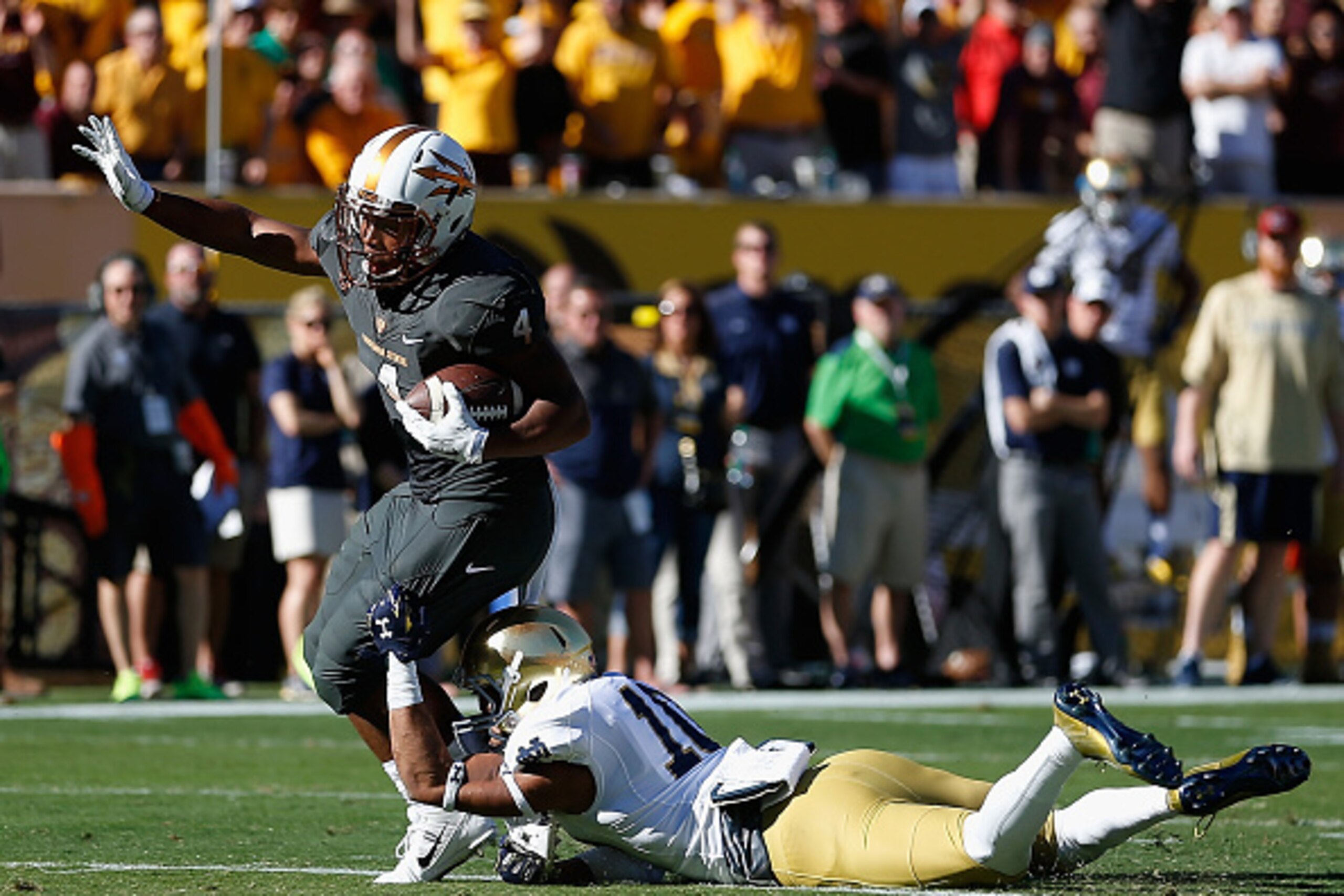 TEMPE, AZ - NOVEMBER 08:  Wide receiver Alonzo Agwuenu #4 of the Arizona State Sun Devils runs with the football after a reception past safety Max Redfield #10 of the Notre Dame Fighting Irish during the first quarter of the college football game at Sun D