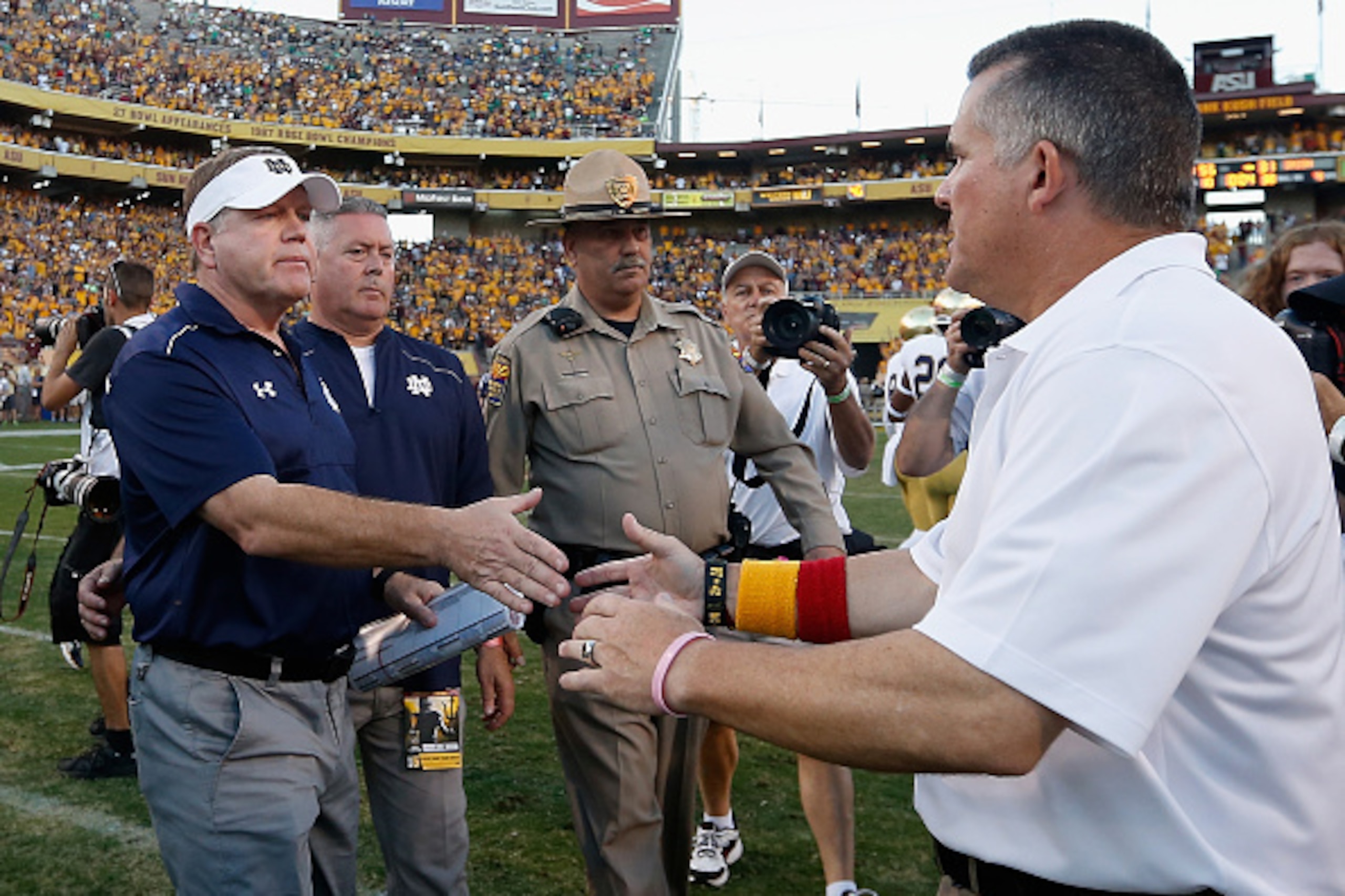 TEMPE, AZ - NOVEMBER 08:  Head coaches Brian Kelly of the Notre Dame Fighting Irish and Todd Graham of the Arizona State Sun Devils shake hands following the college football game at Sun Devil Stadium on November 8, 2014 in Tempe, Arizona.  The Sun Devils