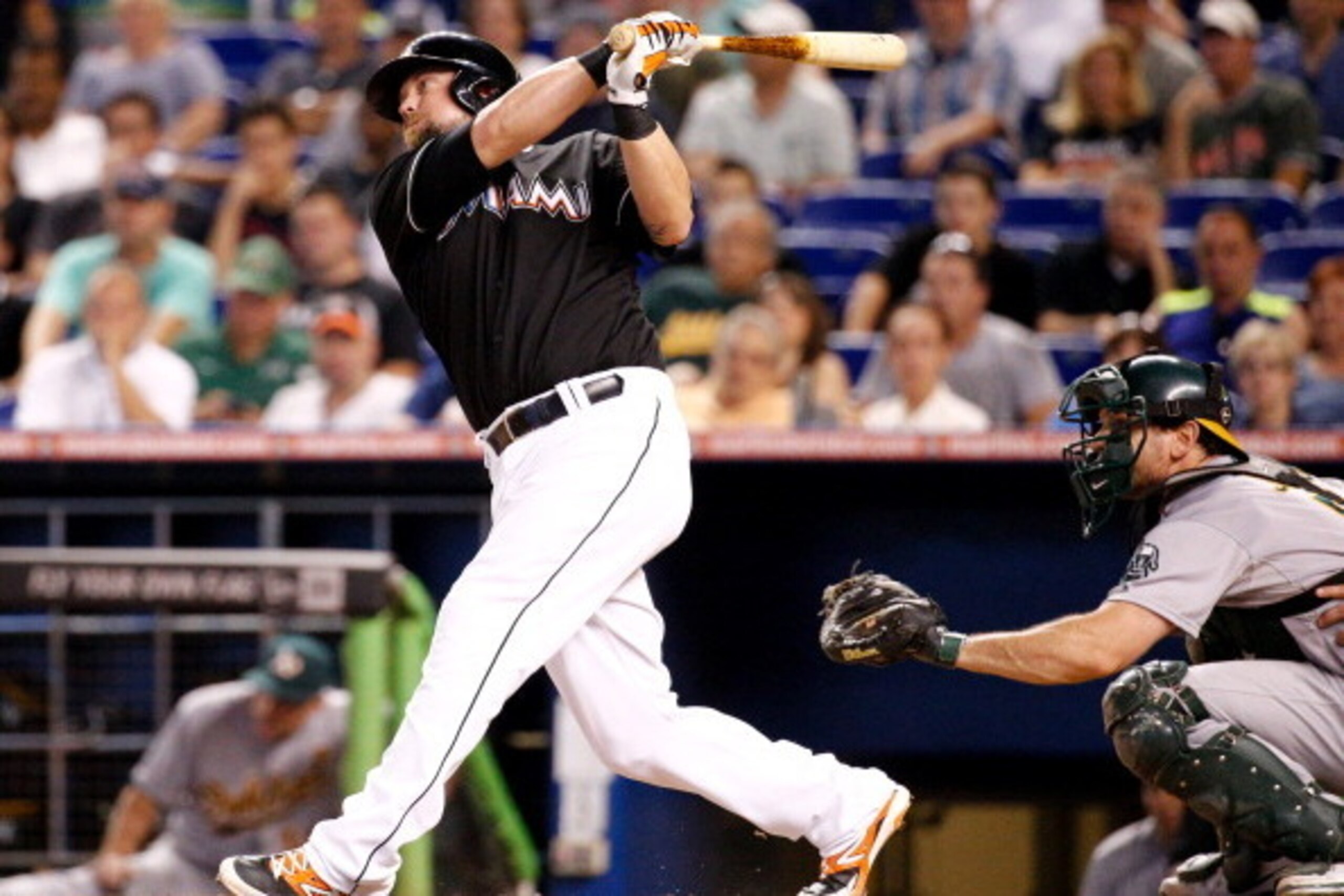 MIAMI, FL - JUNE 28: Casey McGehee #9 of the Miami Marlins hits an hits an RBI single during the ninth inning of the game against the Oakland Athletics at Marlins Park on June 28, 2014 in Miami, Florida.  (Photo by Rob Foldy/Getty Images)