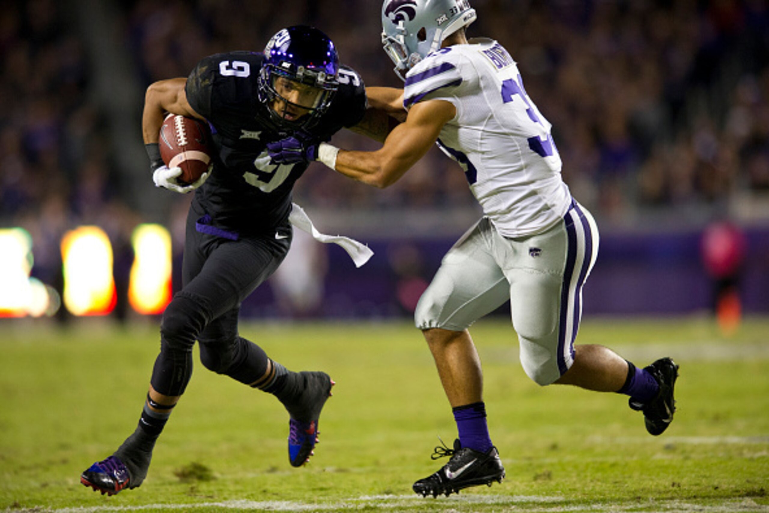 FORT WORTH, TX - NOVEMBER 8:  Josh Doctson #9 of the TCU Horned Frogs is wrapped up by Morgan Burns #33 of the Kansas State Wildcats during the 1st quarter on November 8, 2014 at Amon G. Carter Stadium in Fort Worth, Texas.  (Photo by Cooper Neill/Getty I
