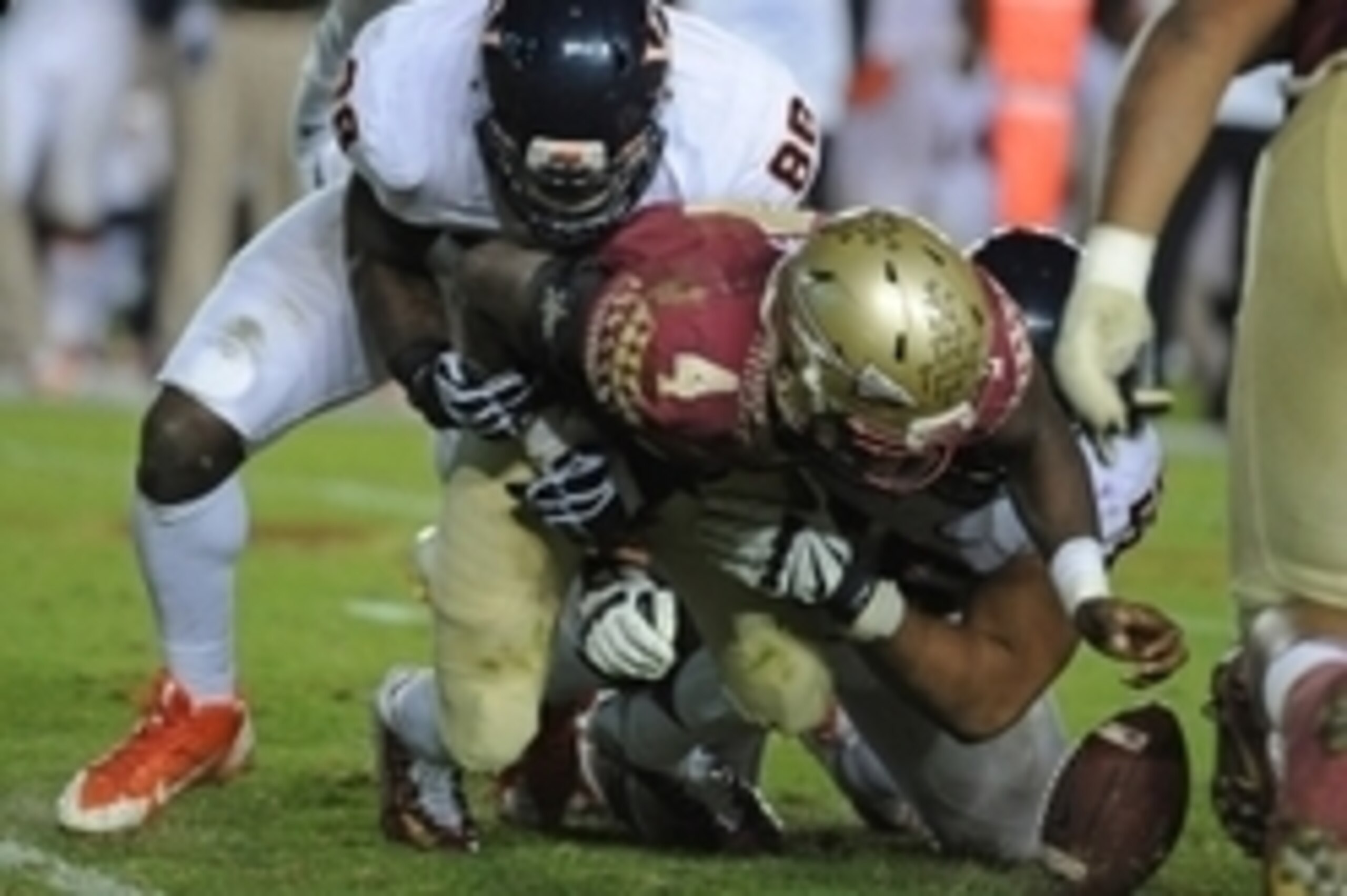 Nov 8, 2014; Tallahassee, FL, USA; Florida State Seminoles running back Dalvin Cook (4) fumbles the ball and is injured in a run play as he is tackled by Virginia Cavaliers linebacker Max Valles (88) during the second half at Doak Campbell Stadium. Mandat