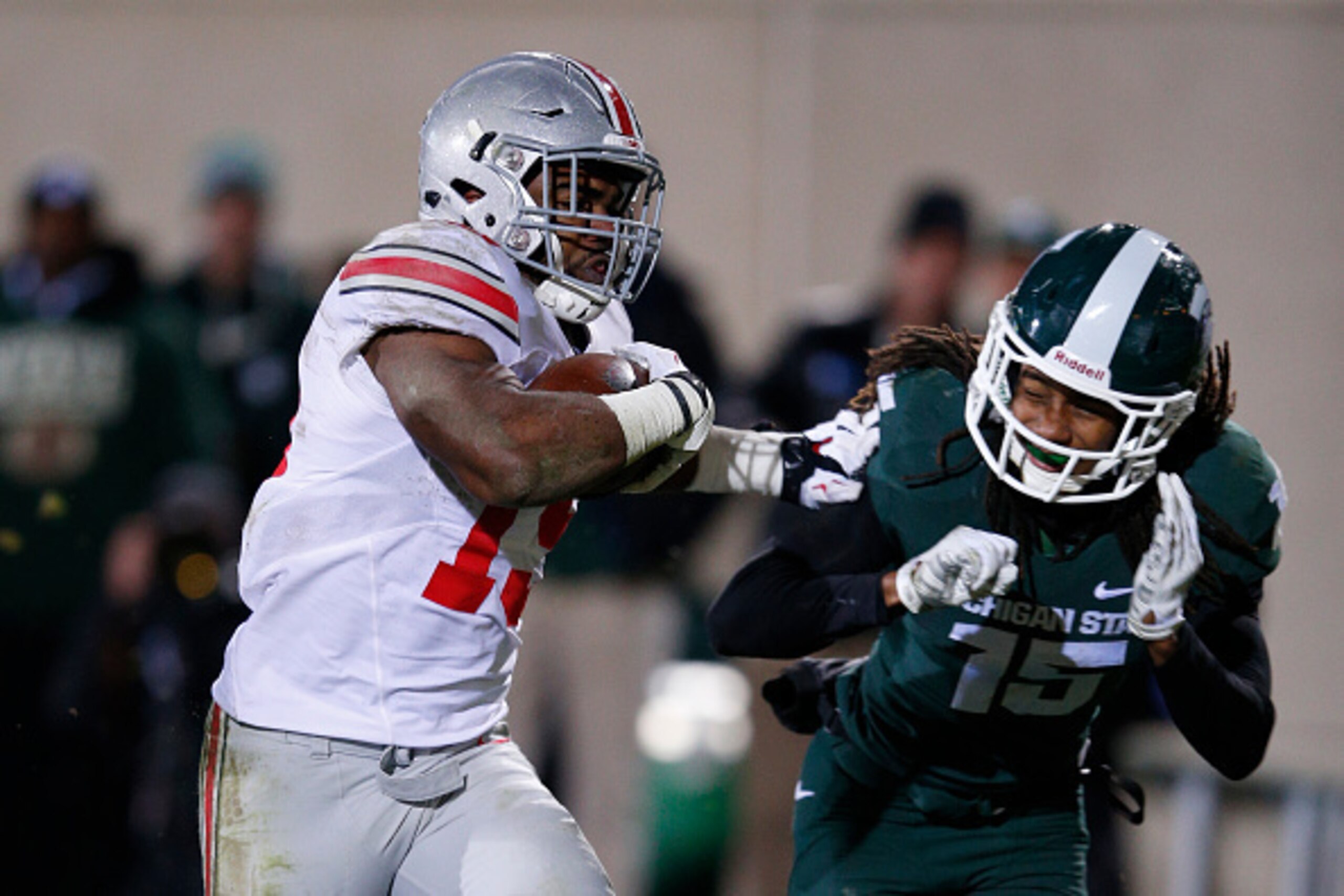 EAST LANSING, MI - NOVEMBER 8: Ezekiel Elliott #15 of the Ohio State Buckeyes rushes for a 17-yard touchdown ahead of Trae Waynes #15 of the Michigan State Spartans in the fourth quarter of the game at Spartan Stadium on November 8, 2014 in East Lansing, 