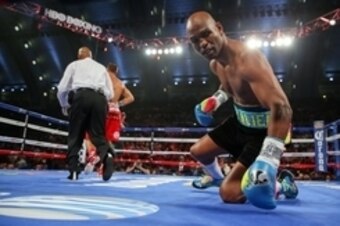 Nov 8, 2014; Atlantic City, NJ, USA; Bernard Hopkins (Black trunks) is knocked down by Sergey Kovalev (Red/White trunks) during their WBA/IBF/WBO light heavyweight title bout at Boardwalk Hall. Mandatory Credit: Ed Mulholland-USA TODAY Sports