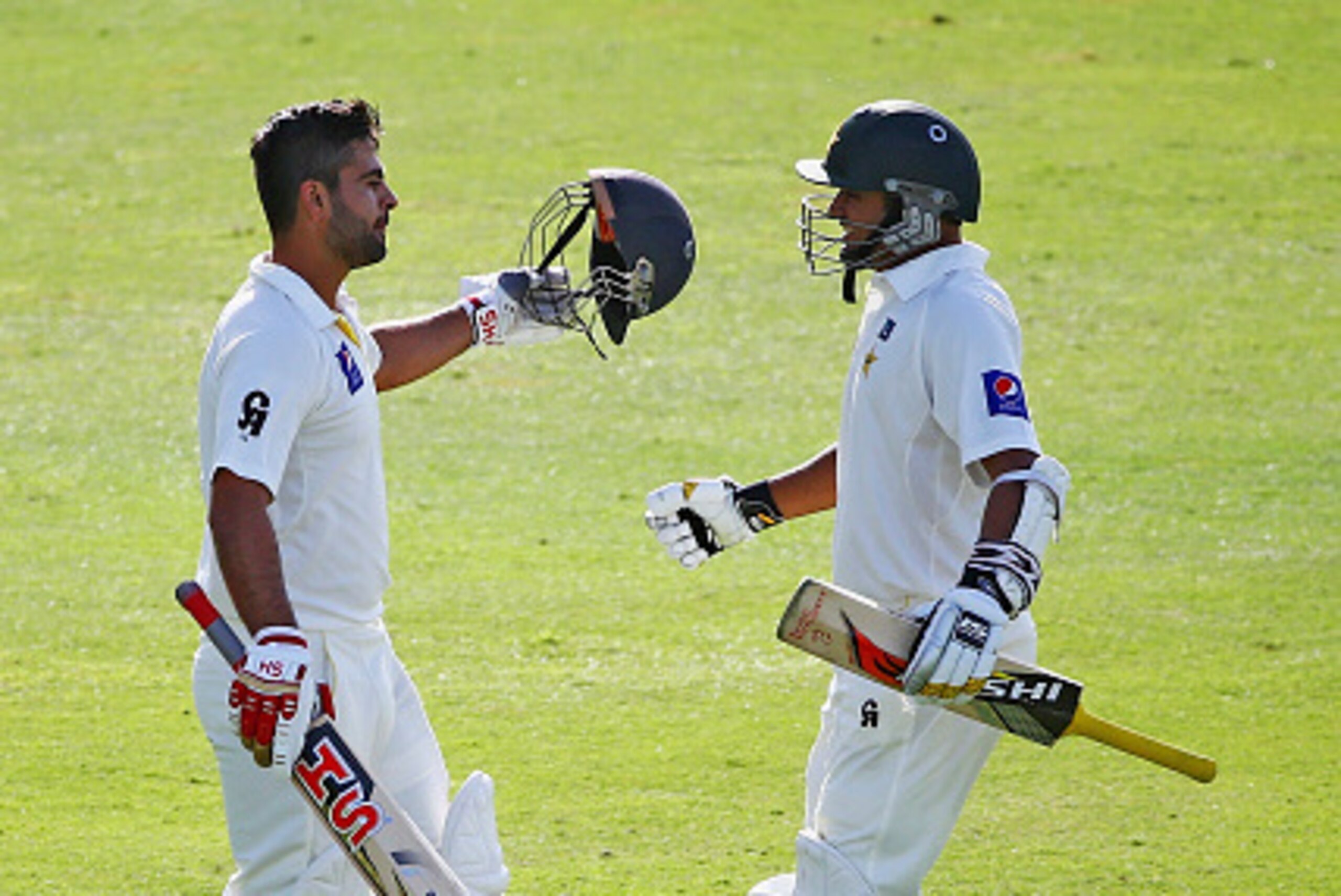 ABU DHABI, UNITED ARAB EMIRATES - NOVEMBER 09:Azhar Ali congratulates Ahmed Shehzad after reaching his century during Day One of the First Test between Pakistan and New Zealand at Sheikh Zayed stadium on November 9, 2014 in Abu Dhabi, United Arab Emirates ABU DHABI, UNITED ARAB EMIRATES - NOVEMBER 09:Azhar Ali congratulates Ahmed Shehzad after reaching his century during Day One of the First Test between Pakistan and New Zealand at Sheikh Zayed stadium on November 9, 2014 in Abu Dhabi, United Arab Emirates