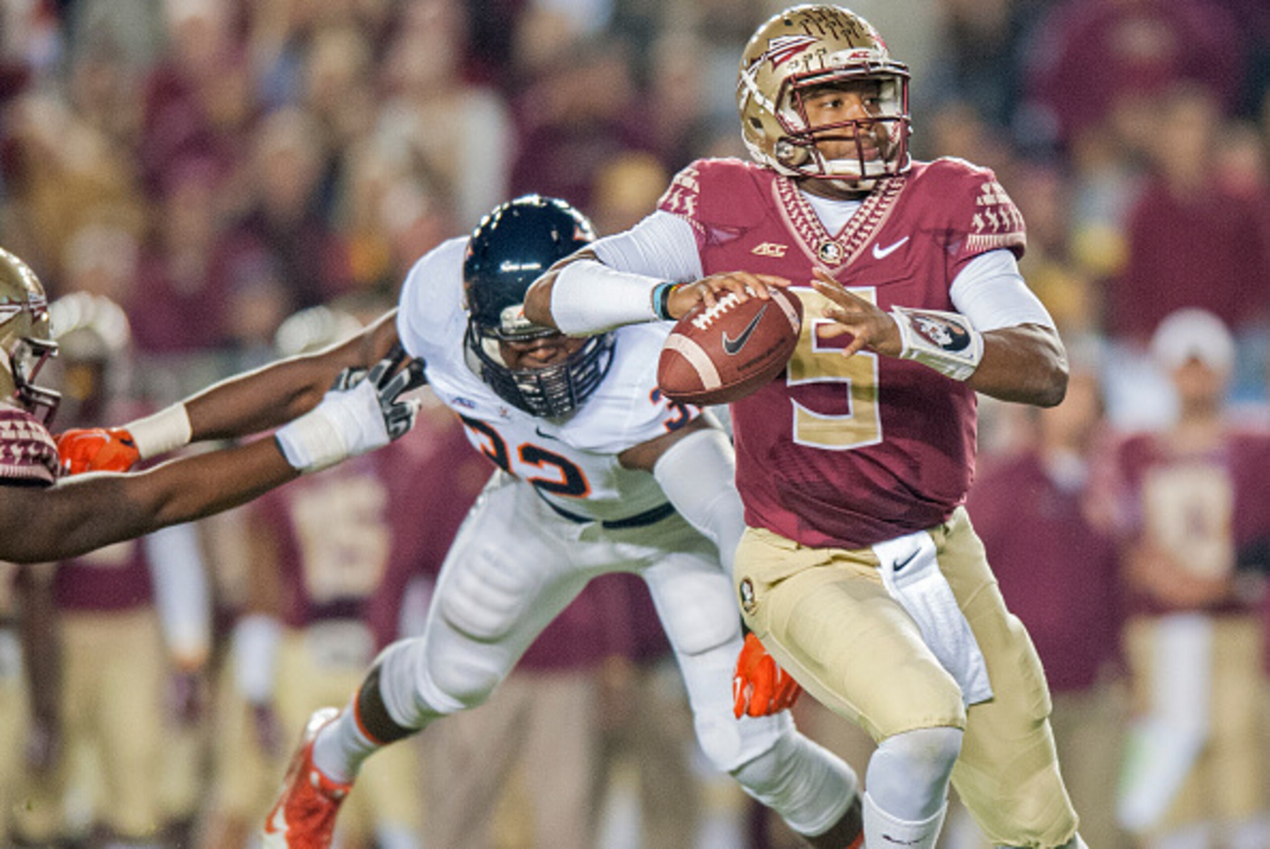 TALLAHASSEE, FL - NOVEMBER 8: Quarterback Jameis Winston #5 of the Florida State Seminoles avoinds a sack against the Virginia Cavaliers during the first half at Doak Campbell Stadium on November 8, 2014 in Tallahassee, Florida. (Photo by Jeff Gammons/Get