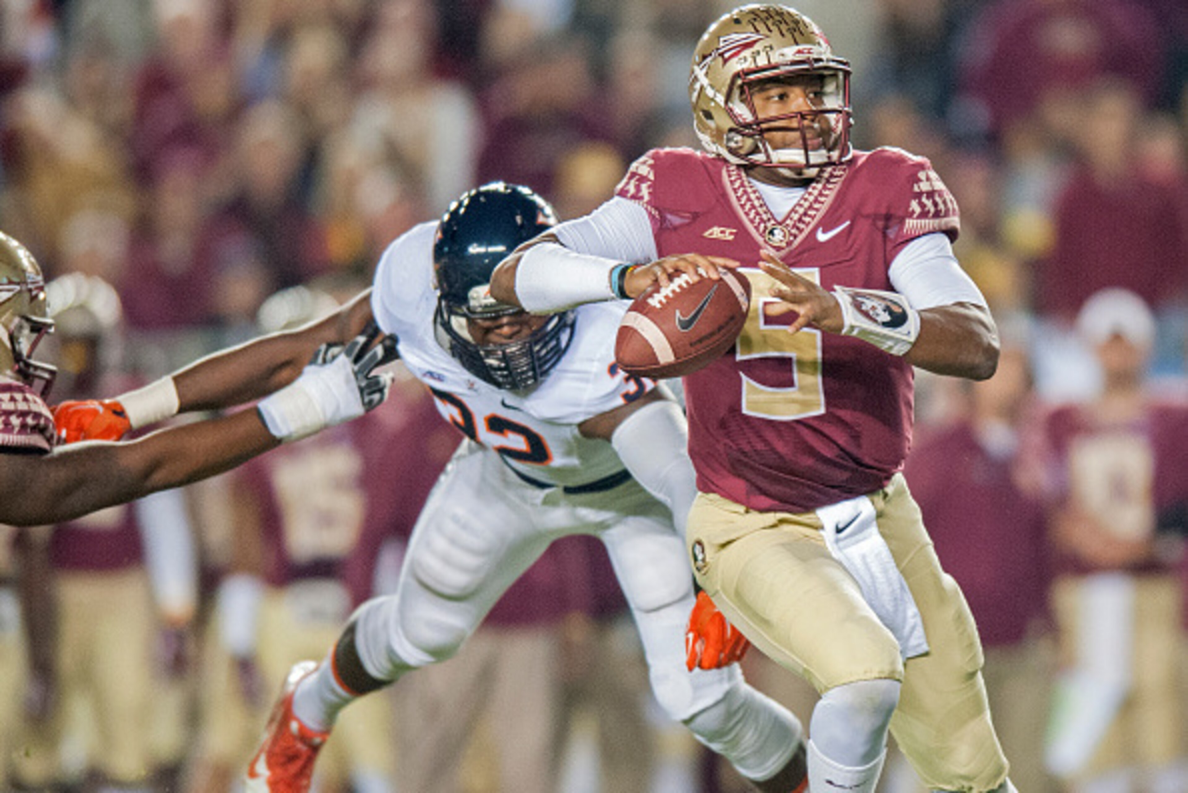 TALLAHASSEE, FL - NOVEMBER 8: Quarterback Jameis Winston #5 of the Florida State Seminoles avoinds a sack against the Virginia Cavaliers during the first half at Doak Campbell Stadium on November 8, 2014 in Tallahassee, Florida. (Photo by Jeff Gammons/Get