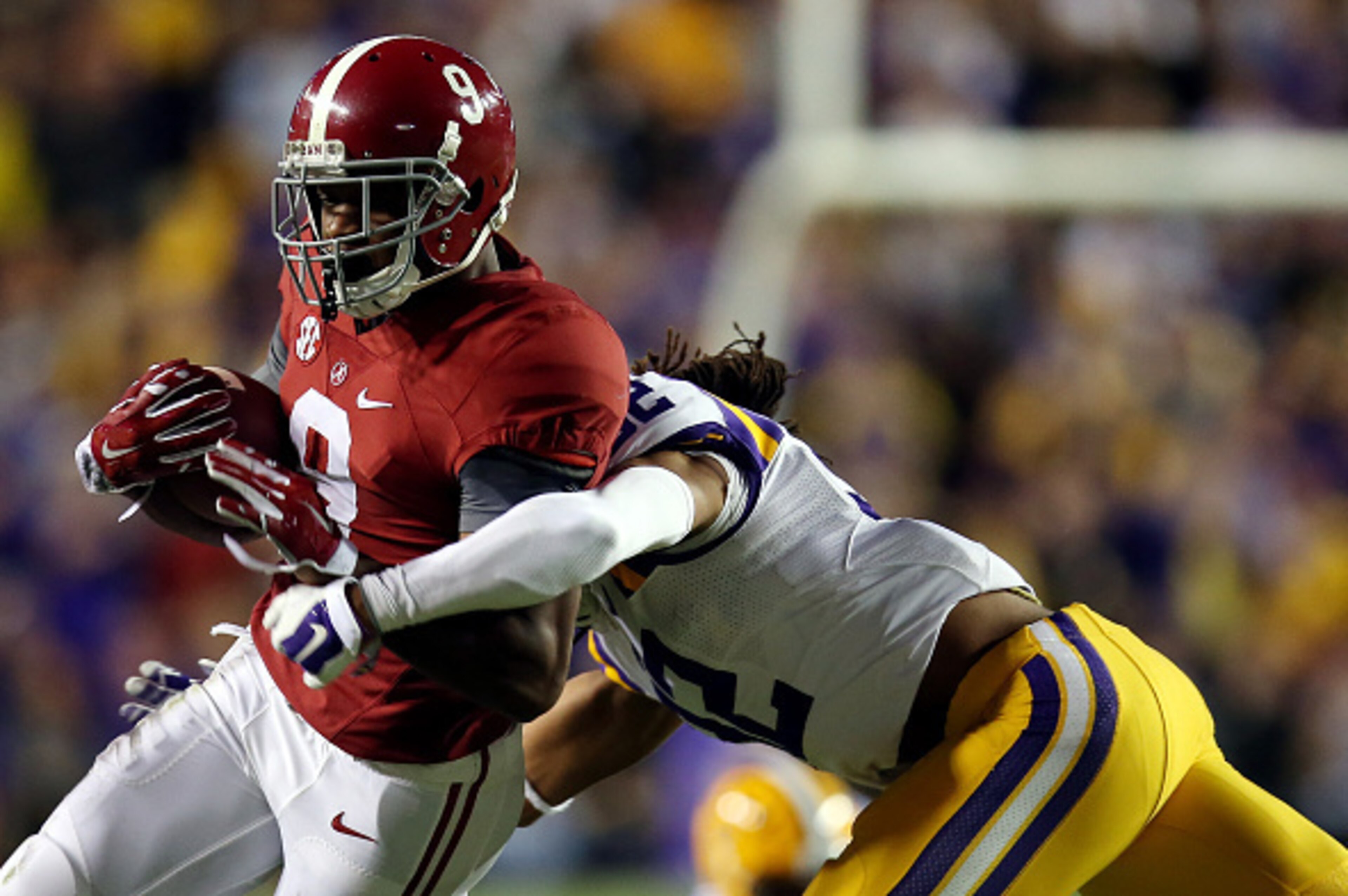 BATON ROUGE, LA - NOVEMBER 08: Amari Cooper #9 of the Alabama Crimson Tide is tackled by Jalen Collins #32 of the LSU Tigers during a game at Tiger Stadium on November 8, 2014 in Baton Rouge, Louisiana.  (Photo by Chris Graythen/Getty Images)