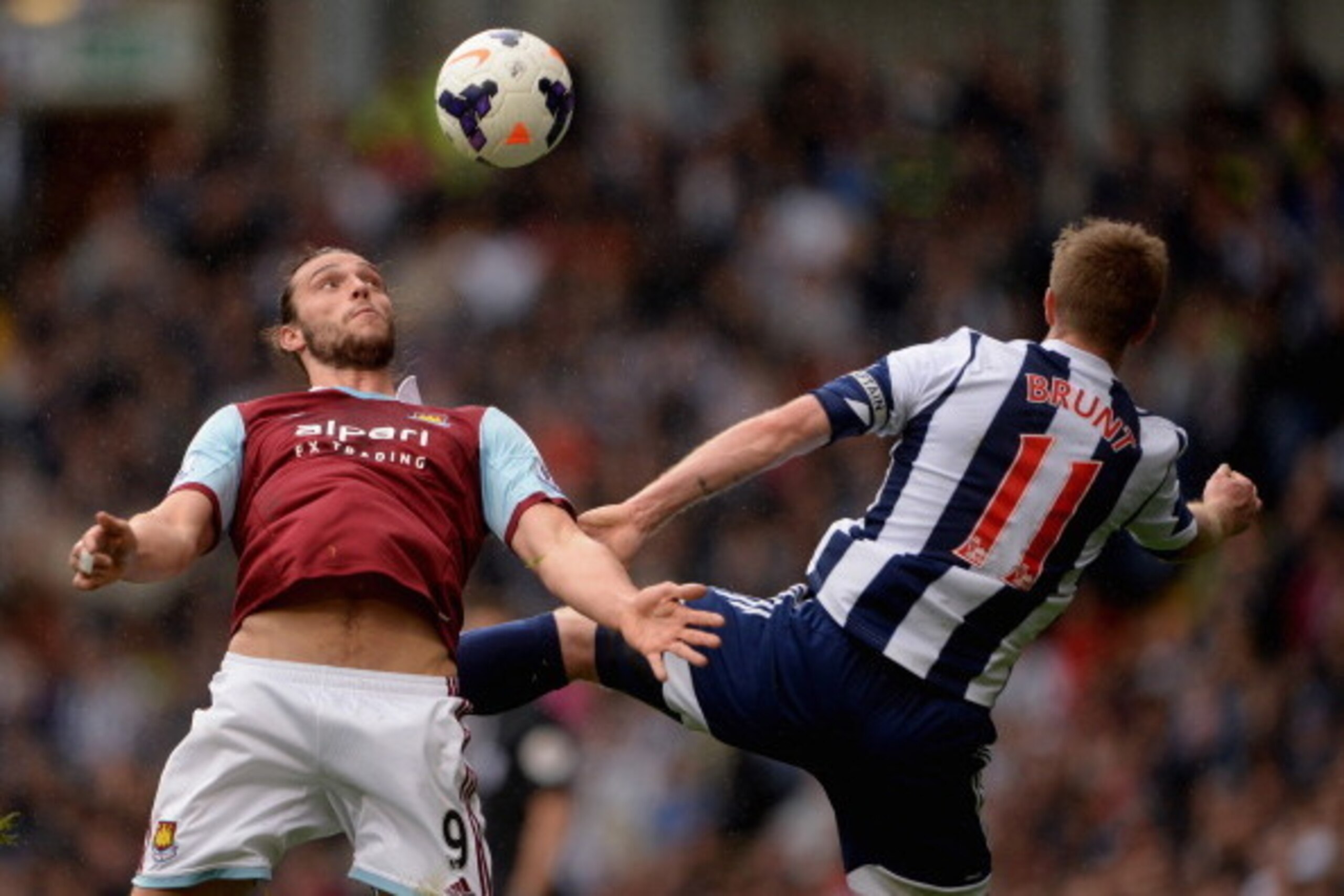 WEST BROMWICH, ENGLAND - APRIL 26:  Andy Carroll of West Ham battles Chris Brunt of West Brom during the Barclays Premier League match between West Bromwich Albion and West Ham United at The Hawthorns on April 26, 2014 in West Bromwich, England.  (Photo b