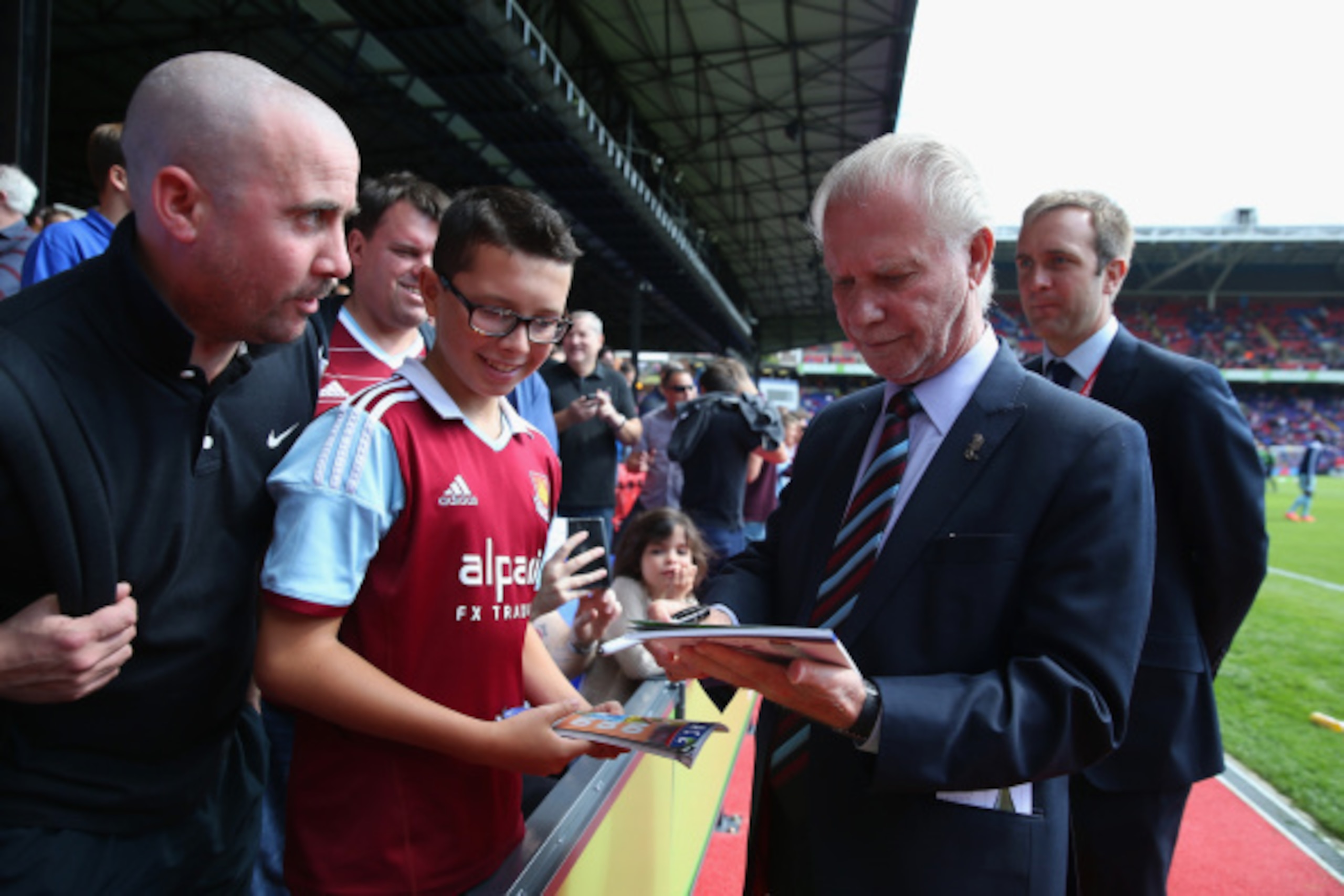 LONDON, ENGLAND - AUGUST 23:  David Gold Chairman of West Ham signs autographs ahead of the Barclays Premier League match between Crystal Palace and West Ham United at Selhurst Park on August 23, 2014 in London, England.  (Photo by Scott Heavey/Getty Imag