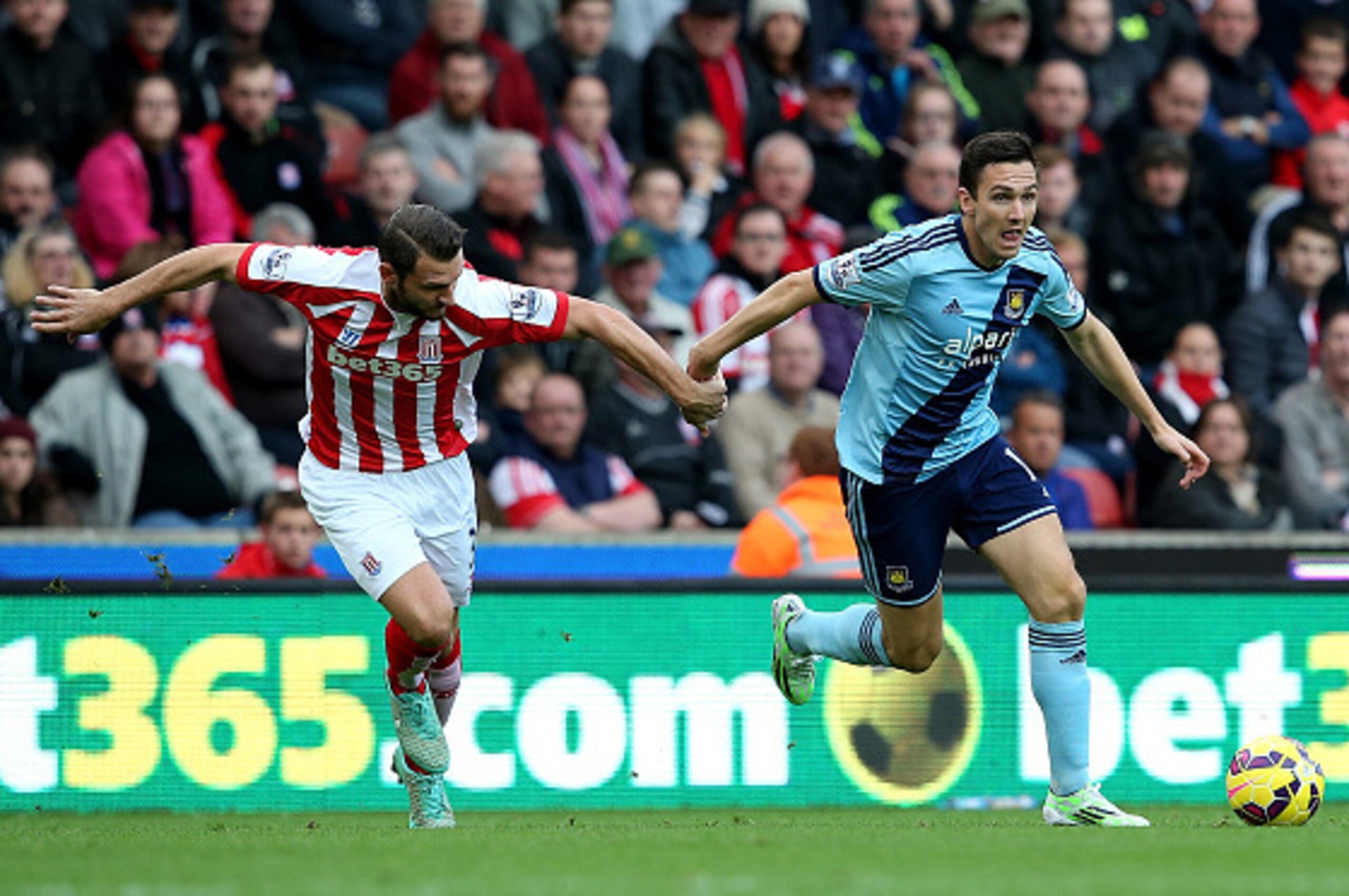 STOKE ON TRENT, ENGLAND - NOVEMBER 01:  Erik Pieters of Stoke City competes with Stewart Downing of West Ham during the Barclays Premier League match between Stoke City and West Ham United at the Britannia Stadium on November 1, 2014 in Stoke on Trent, En
