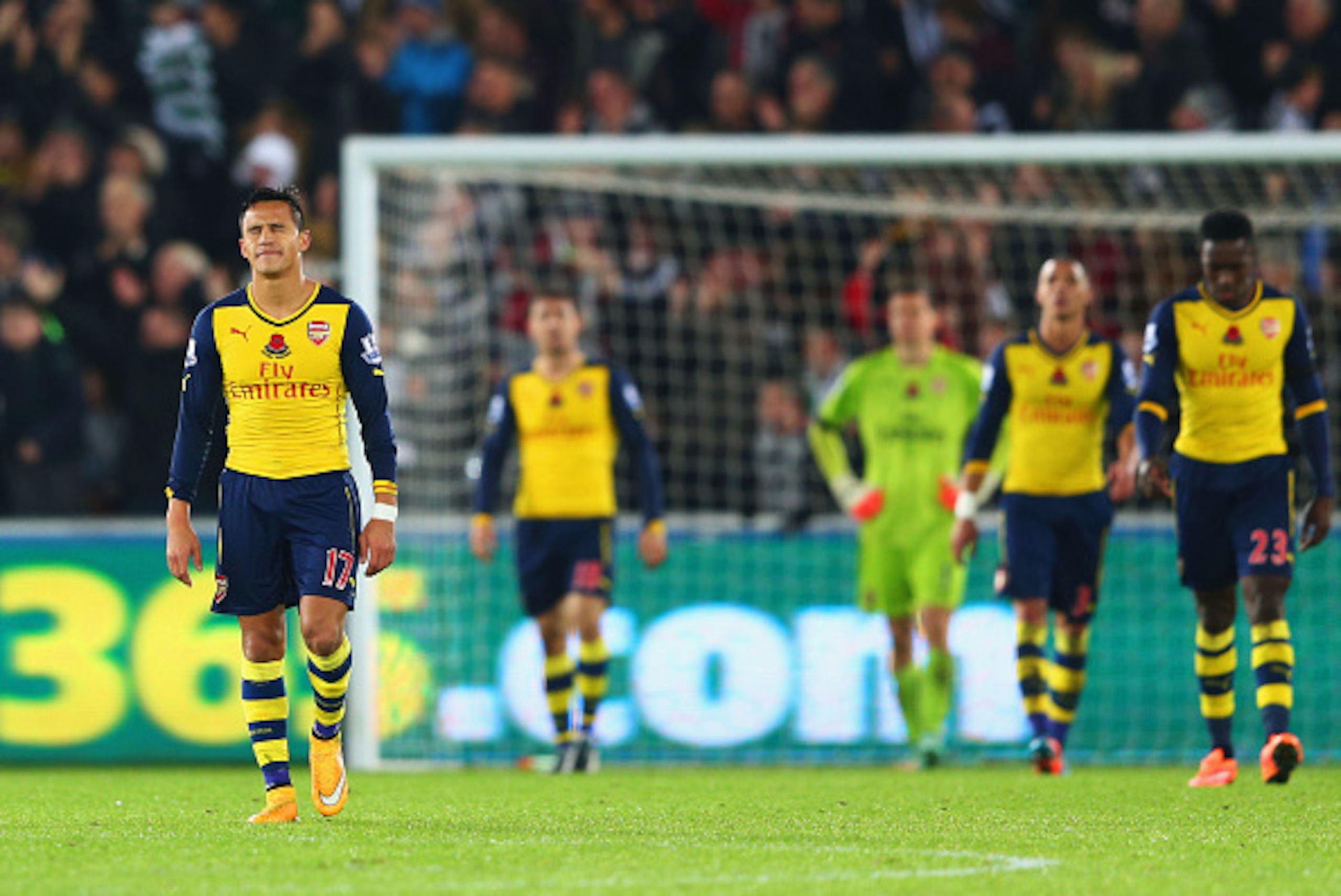 SWANSEA, WALES - NOVEMBER 09:  Alexis Sanchez of Arsenal (L) and team mates look dejected as they concede a goal during the Barclays Premier League match between Swansea City and Arsenal at Liberty Stadium on November 9, 2014 in Swansea, Wales.  (Photo by