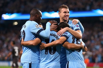 MANCHESTER, ENGLAND - SEPTEMBER 30:  Sergio Aguero of Manchester City celebrates scoring the opening goal from a penalty kick with his team-mates during the UEFA Champions League Group E match between Manchester City FC and AS Roma  on September 30, 2014 