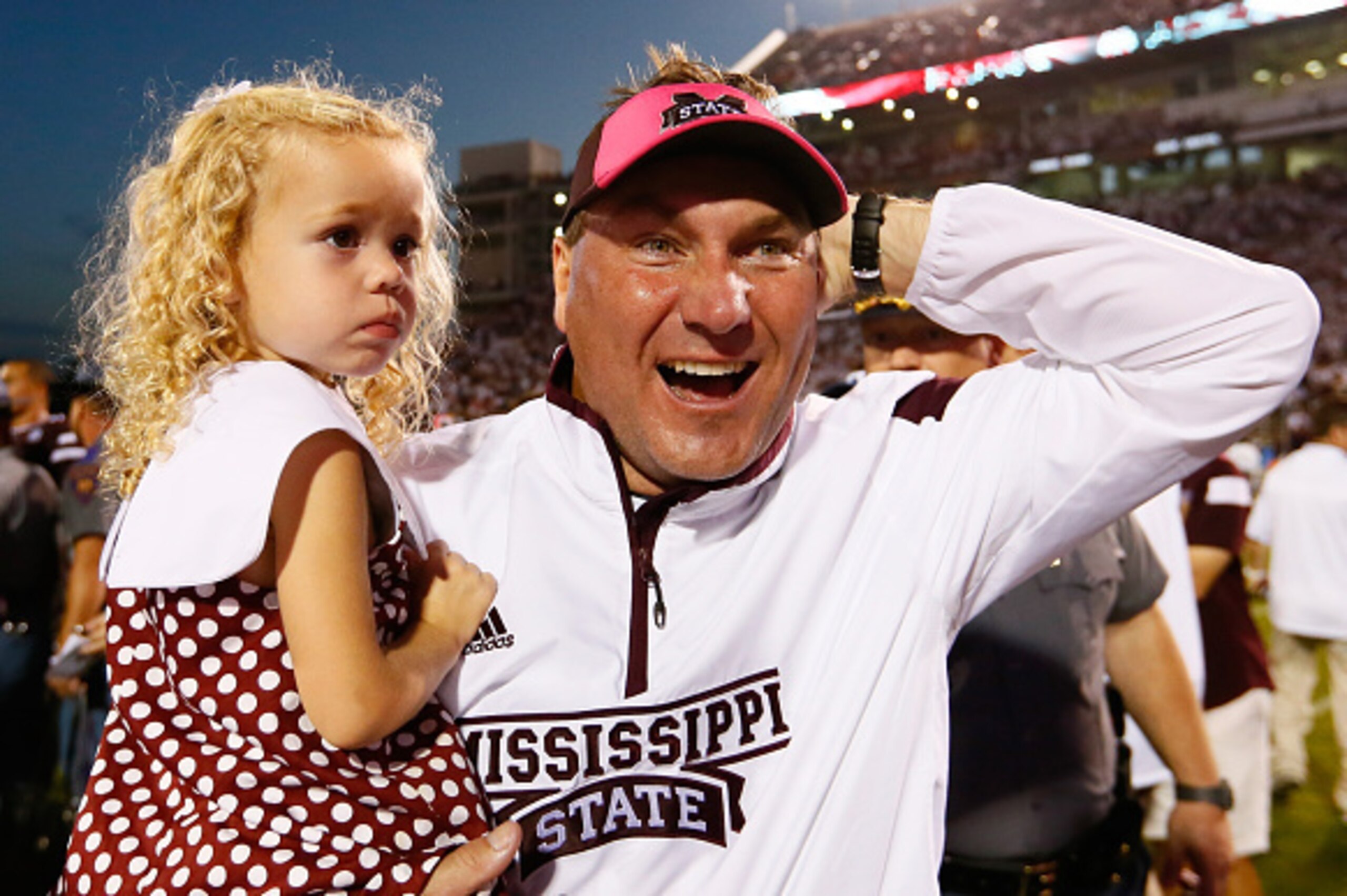 STARKVILLE, MS - OCTOBER 11:  Head coach Dan Mullen of the Mississippi State Bulldogs celebrates their 38-23 win over the Auburn Tigers with daughter Breelyn at Davis Wade Stadium on October 11, 2014 in Starkville, Mississippi.  (Photo by Kevin C. Cox/Get