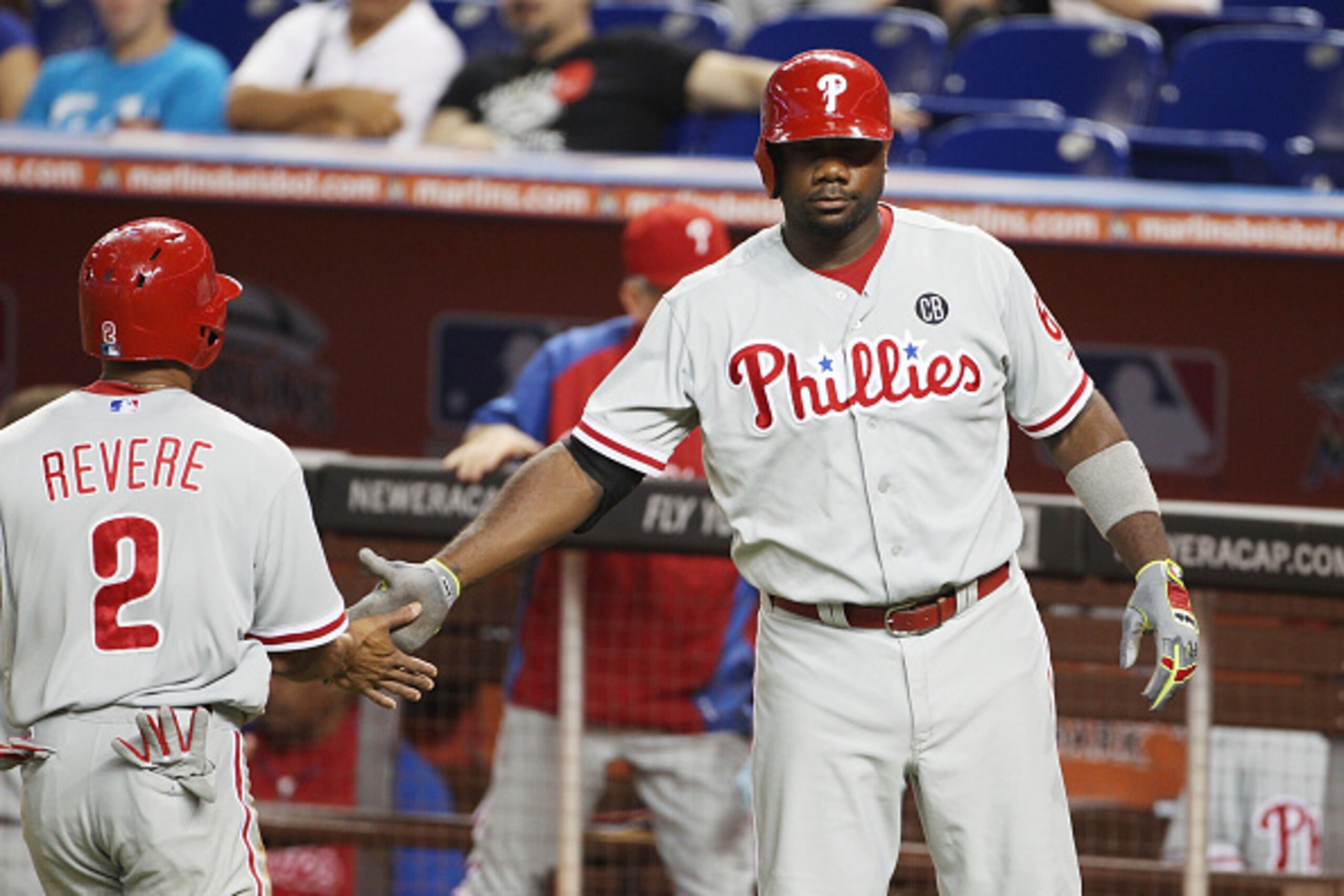 MIAMI, FL - SEPTEMBER 25: Ryan Howard #6 and Ben Revere #2 of the Philadelphia Phillies celebrate a run during the first inning against the Miami Marlins at Marlins Park on September 25, 2014 in Miami, Florida.  (Photo by Marc Serota/Getty Images)
