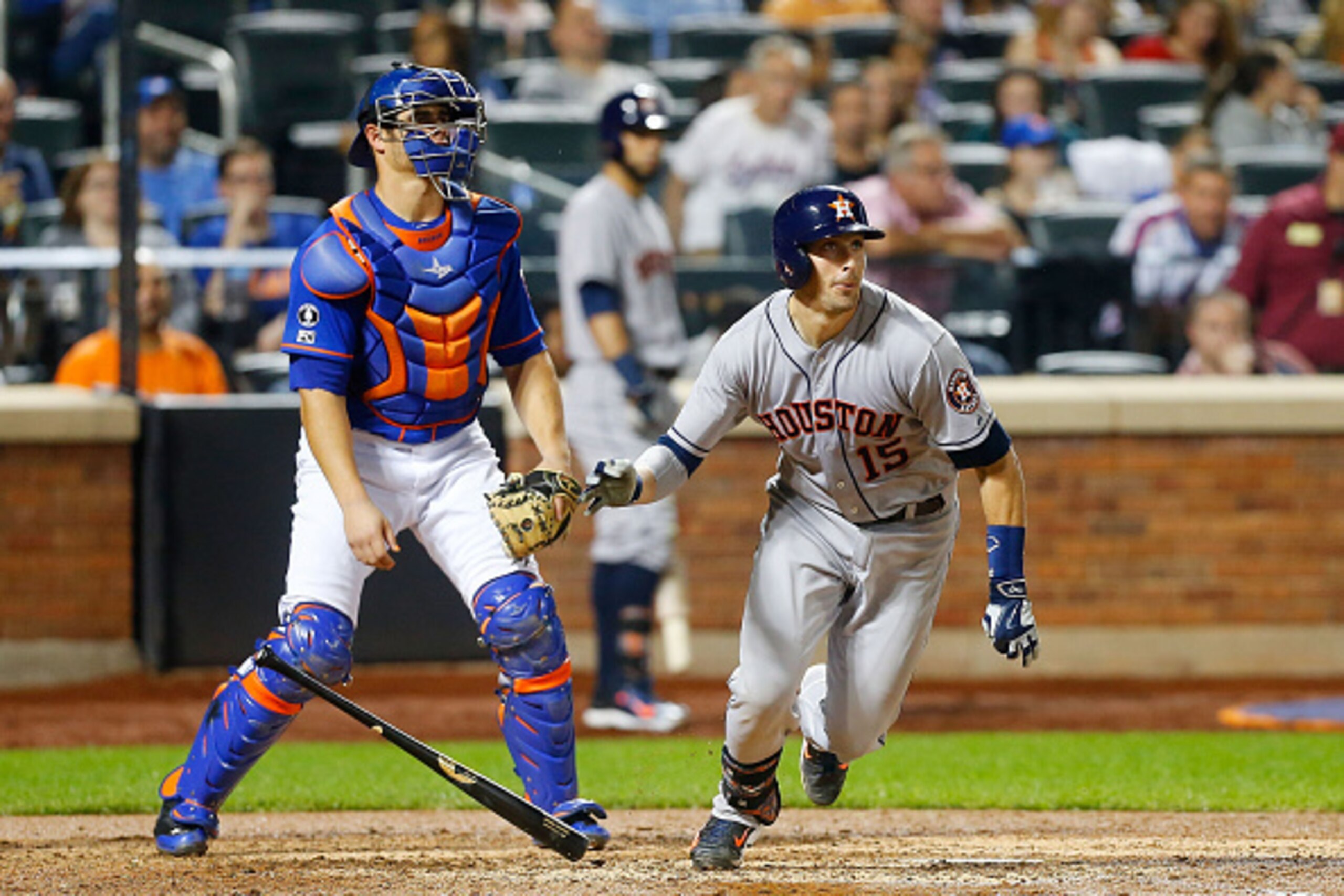 NEW YORK, NY - SEPTEMBER 27:  Jason Castro #15 of the Houston Astros follows through on a sixth inning RBI double as catcher Anthony Recker #20 of the New York Mets watches at Citi Field on September 27, 2014 in the Flushing neighborhood of the Queens bor