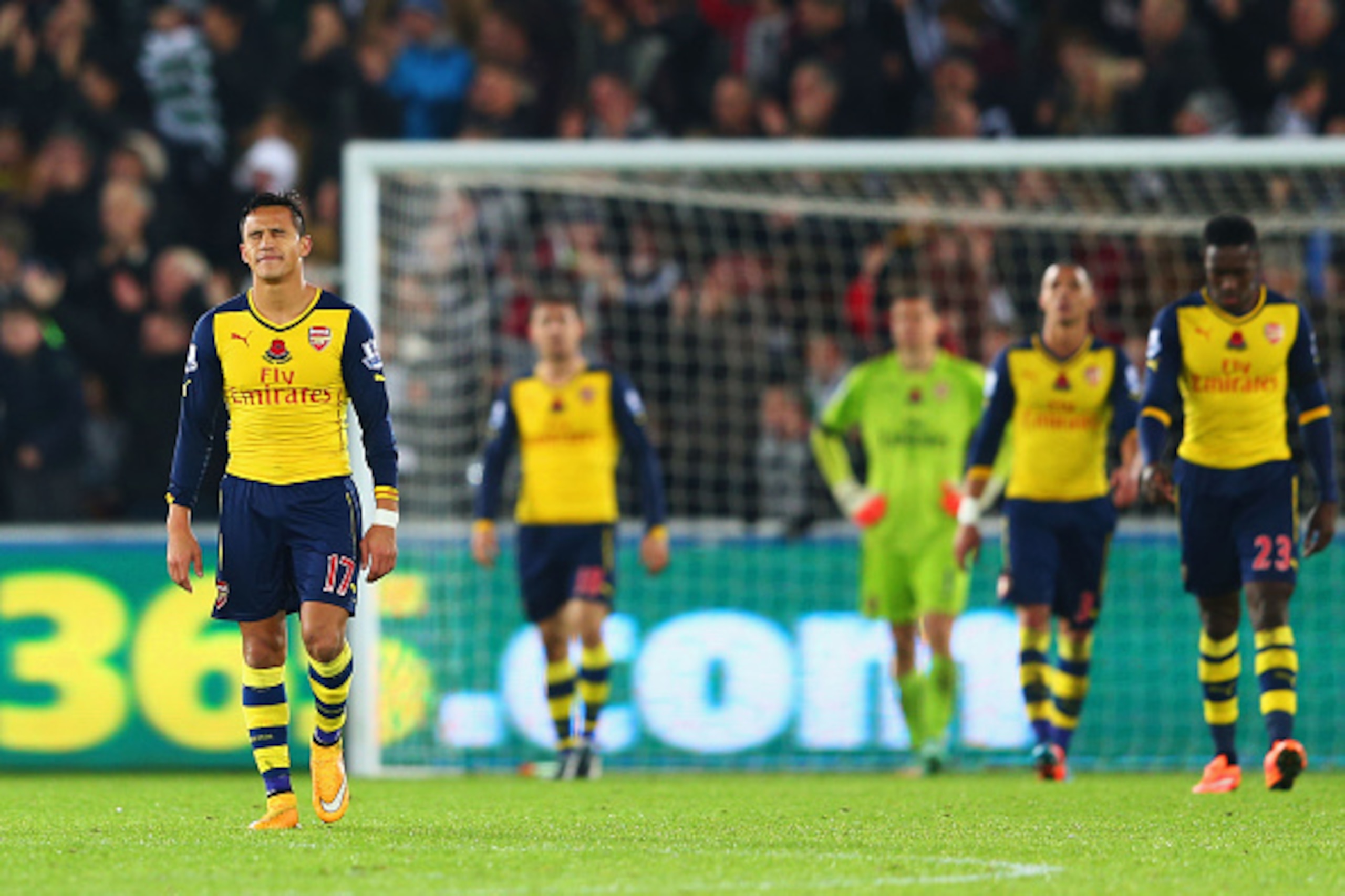 SWANSEA, WALES - NOVEMBER 09:  Alexis Sanchez of Arsenal (L) and team mates look dejected as they concede a goal during the Barclays Premier League match between Swansea City and Arsenal at Liberty Stadium on November 9, 2014 in Swansea, Wales.  (Photo by