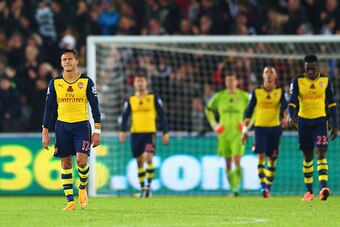 SWANSEA, WALES - NOVEMBER 09:  Alexis Sanchez of Arsenal (L) and team mates look dejected as they concede a goal during the Barclays Premier League match between Swansea City and Arsenal at Liberty Stadium on November 9, 2014 in Swansea, Wales.  (Photo by