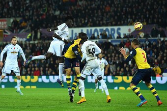 SWANSEA, WALES - NOVEMBER 09:  Swansea player Bafetimbi Gomis (c) heads the second Swansea goal during the Barclays Premier League match between Swansea City and Arsenal at Liberty Stadium on November 9, 2014 in Swansea, Wales.  (Photo by Stu Forster/Gett