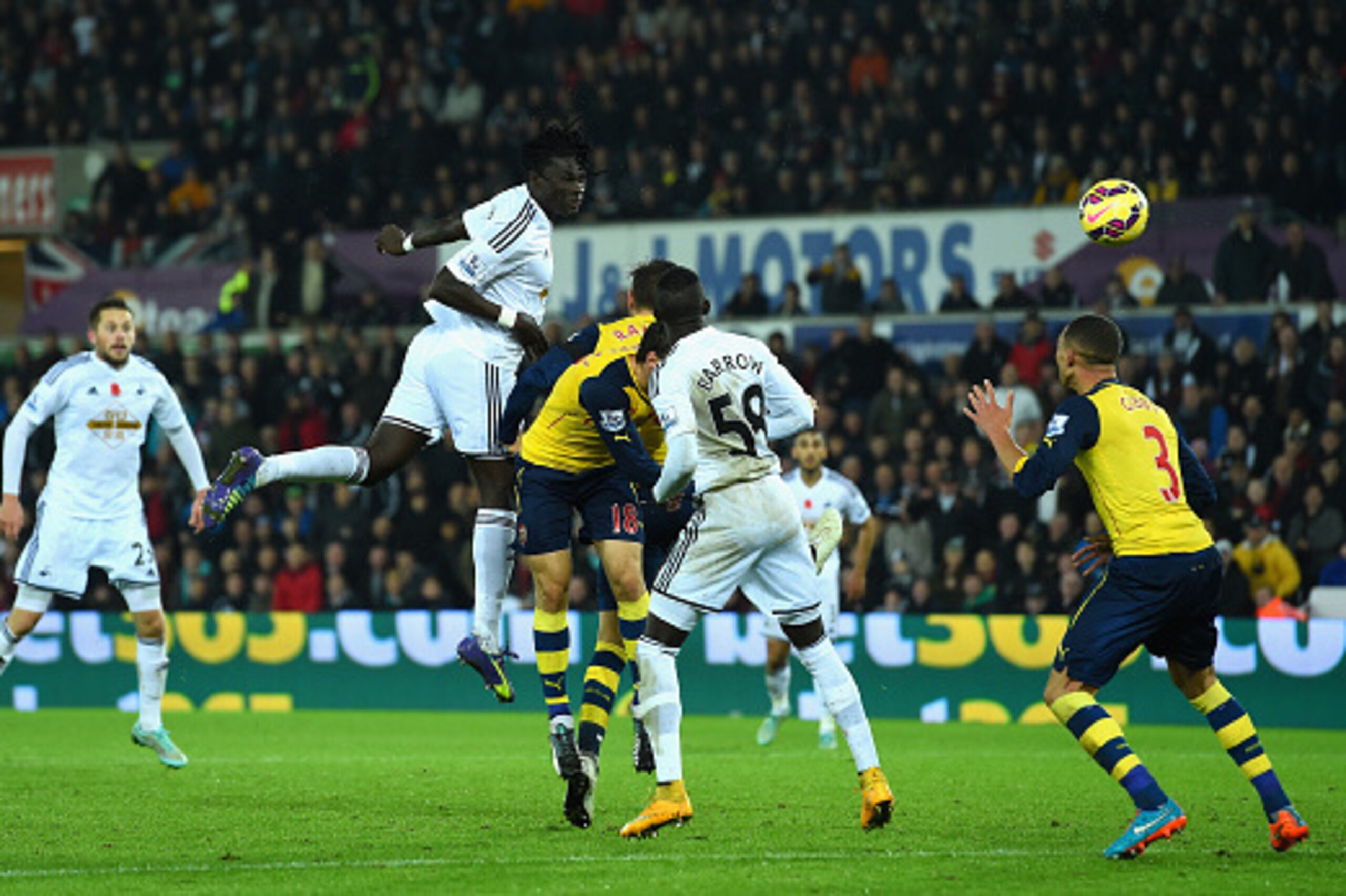 SWANSEA, WALES - NOVEMBER 09:  Swansea player Bafetimbi Gomis (c) heads the second Swansea goal during the Barclays Premier League match between Swansea City and Arsenal at Liberty Stadium on November 9, 2014 in Swansea, Wales.  (Photo by Stu Forster/Gett