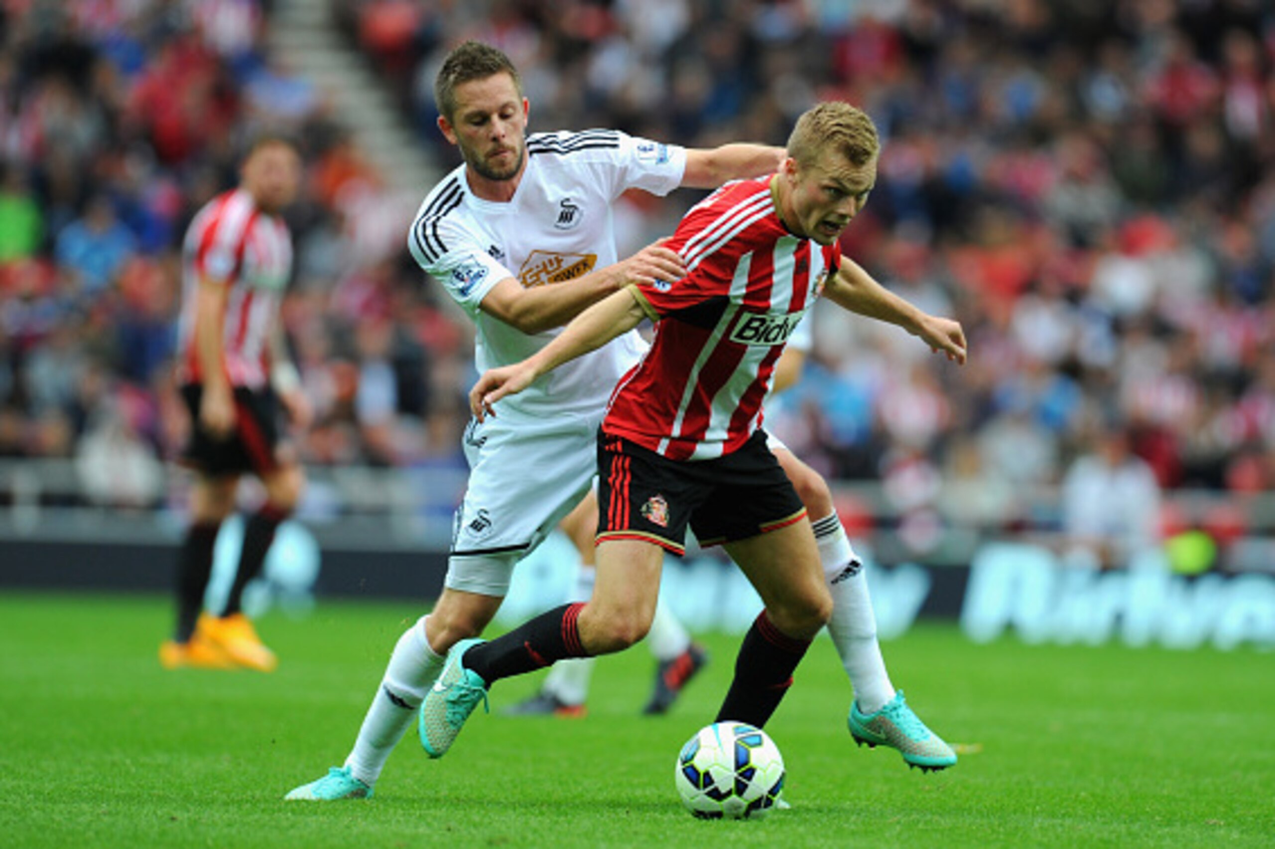 SUNDERLAND, ENGLAND - SEPTEMBER 27:  Swansea player Gylfi Sigurdsson challenges Sebastian Larsson of Sunderland during the Barclays Premier League match between Sunderland and Swansea City at Stadium of Light on September 27, 2014 in Sunderland, England. 