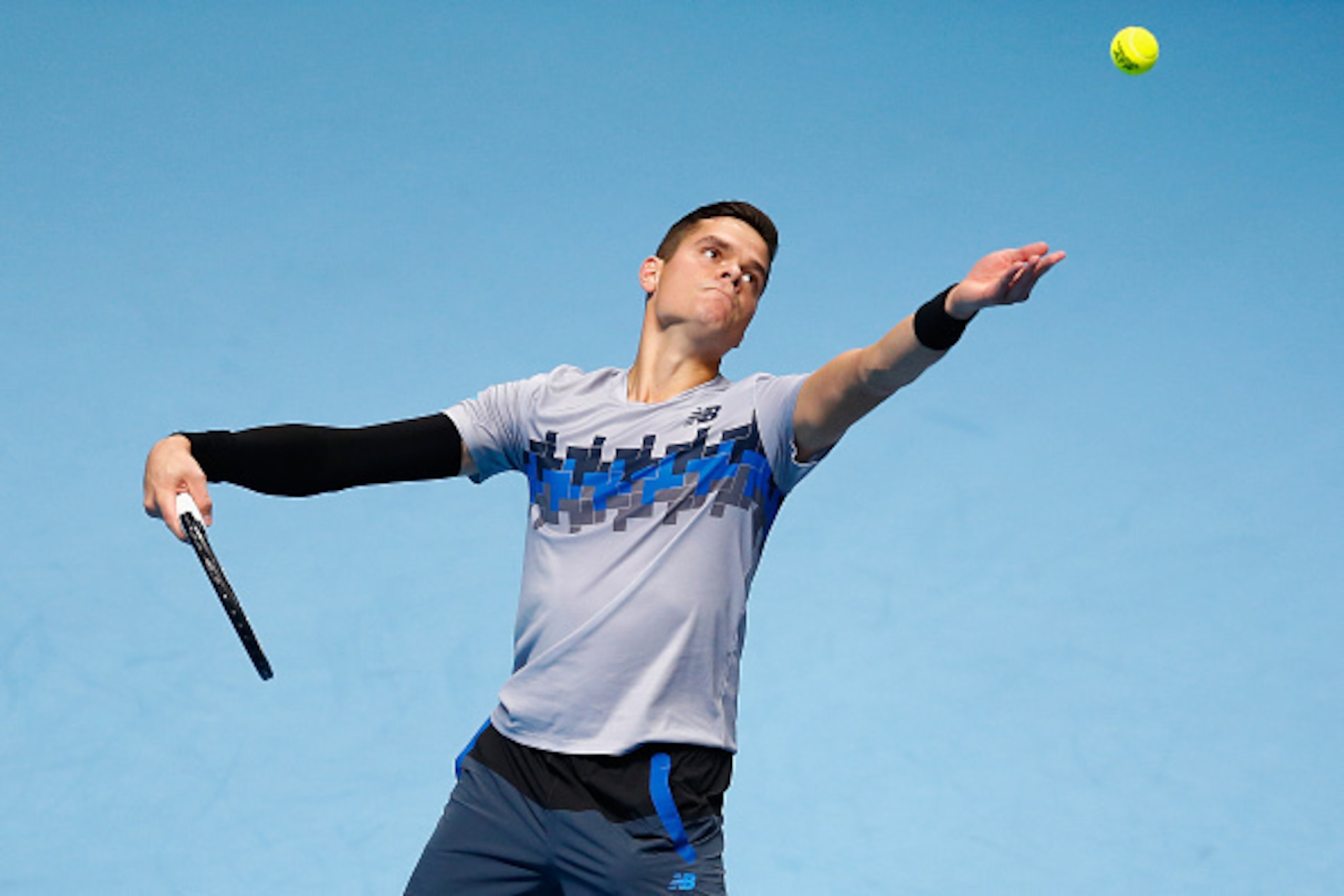 LONDON, ENGLAND - NOVEMBER 09: Milos Raonic of Canada in action in his match against Roger Federer of Switzerland in the round robin during day one of the Barclays ATP World Tour Finals tennis at O2 Arena on November 9, 2014 in London, England. (Photo b LONDON, ENGLAND - NOVEMBER 09: Milos Raonic of Canada in action in his match against Roger Federer of Switzerland in the round robin during day one of the Barclays ATP World Tour Finals tennis at O2 Arena on November 9, 2014 in London, England. (Photo b