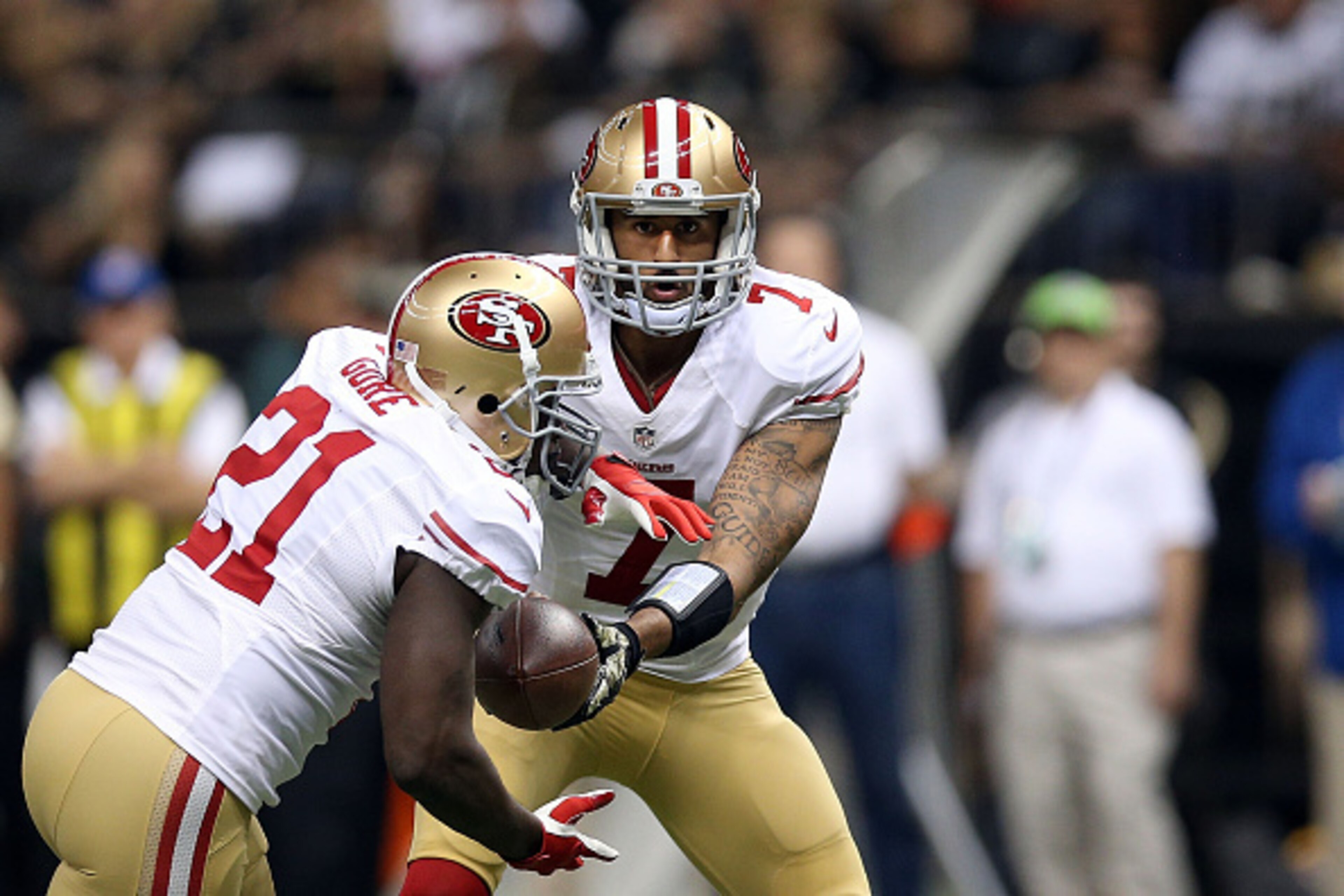 NEW ORLEANS, LA - NOVEMBER 09: Colin Kaepernick #7 hands the ball to Frank Gore #21 of the San Francisco 49ers during the first quarter of a game against the New Orleans Saints at the Mercedes-Benz Superdome on November 9, 2014 in New Orleans, Louisiana. NEW ORLEANS, LA - NOVEMBER 09: Colin Kaepernick #7 hands the ball to Frank Gore #21 of the San Francisco 49ers during the first quarter of a game against the New Orleans Saints at the Mercedes-Benz Superdome on November 9, 2014 in New Orleans, Louisiana.