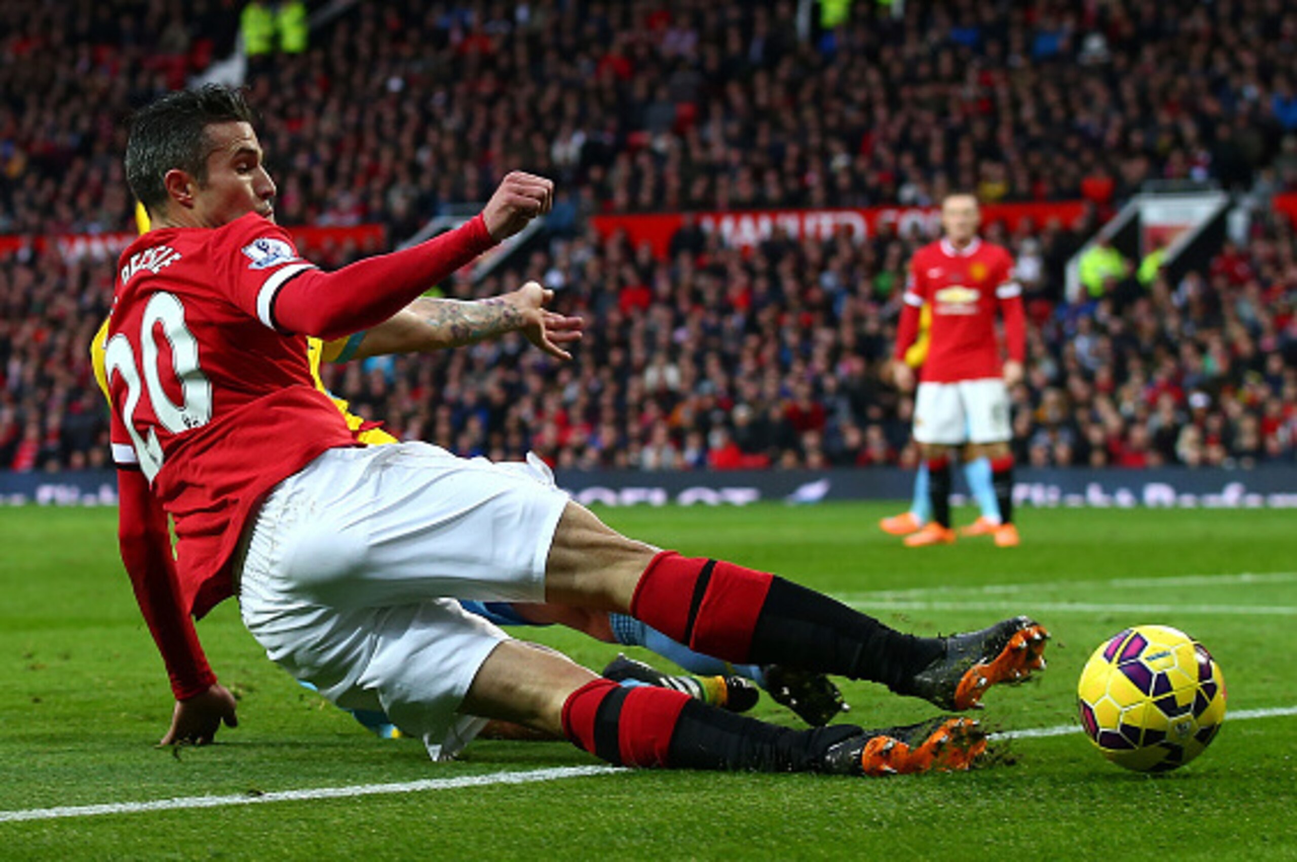 MANCHESTER, ENGLAND - NOVEMBER 08:  Robin van Persie of Manchester United slides in for the ball during the Barclays Premier League match between Manchester United and Crystal Palace at Old Trafford on November 8, 2014 in Manchester, England.  (Photo by C