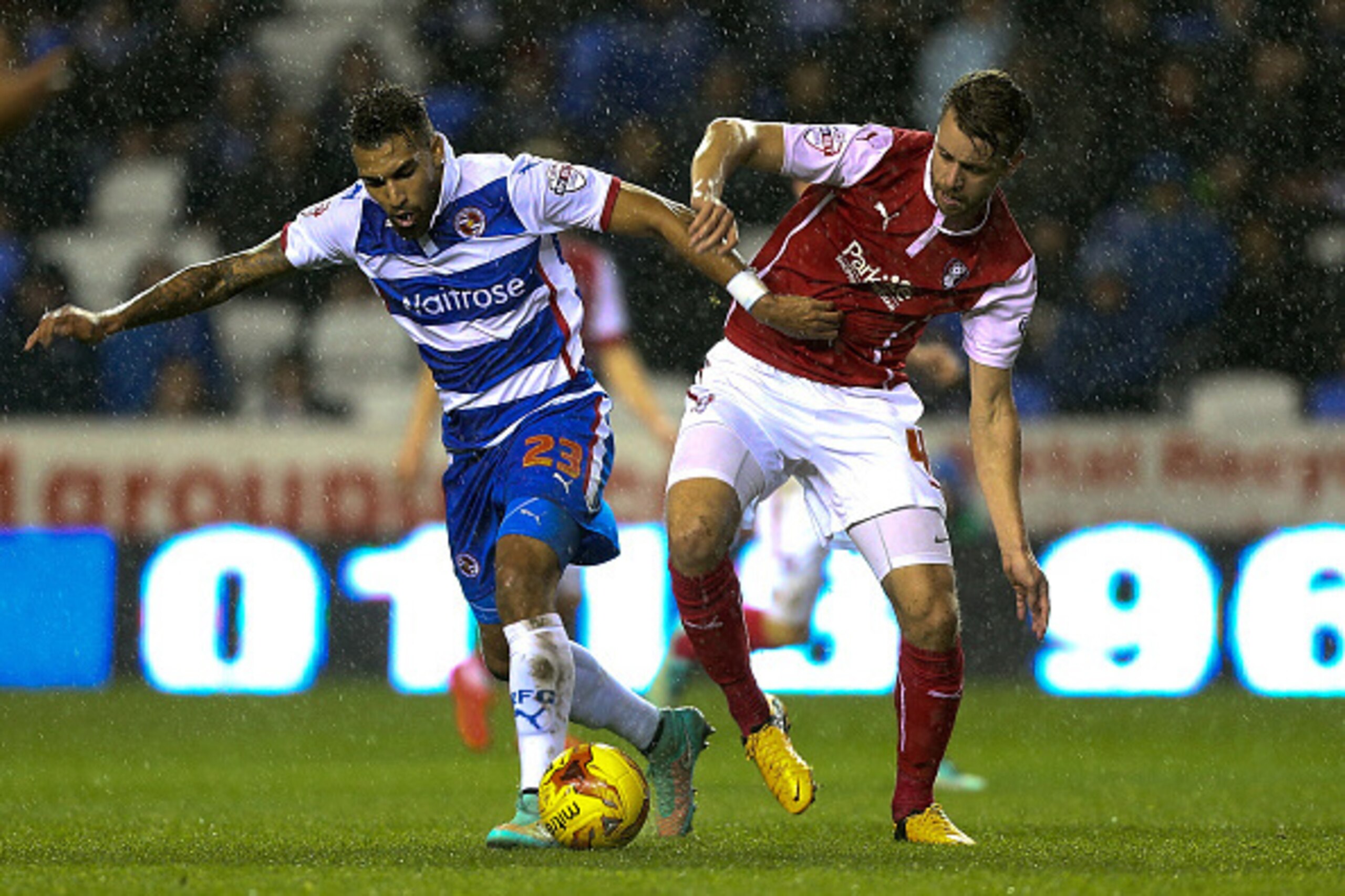 READING, ENGLAND - NOVEMBER 04:  Danny Williams of Reading holds off the challenge of Karl Arnason of Rotherham during the Sky Bet Championship match between Reading and Rotherham United at Madejski Stadium on November 04, 2014 in Reading, England,  (Phot