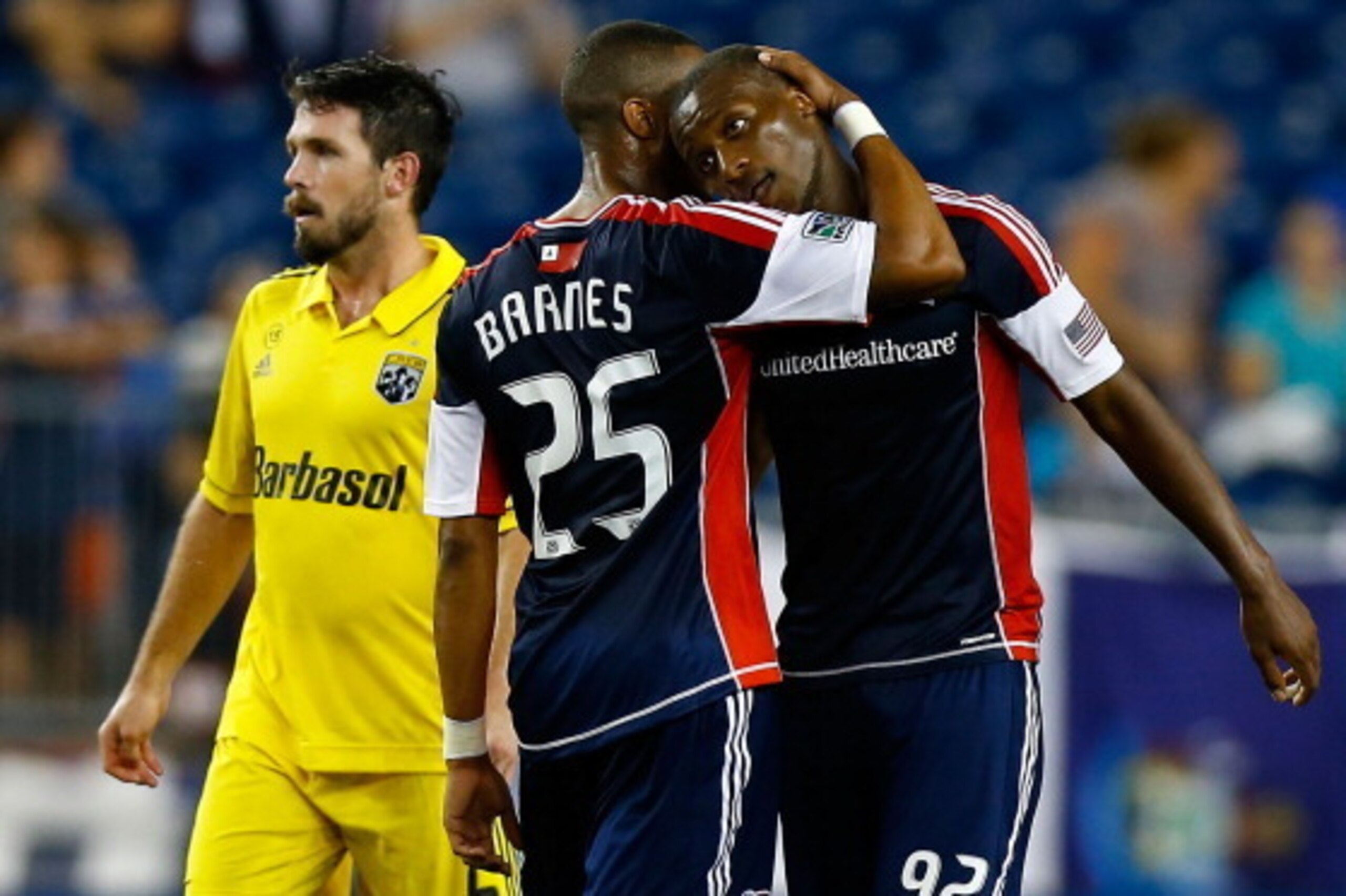 FOXBORO, MA - SEPTEMBER 05:  Dimitry Imbongo #92 of the New England Revolution is congratulated by teammate Darrius Barnes #25 following his goal against the Columbus Crew during the game against the on September 5, 2012 at Gillette Stadium in Foxboro, Ma