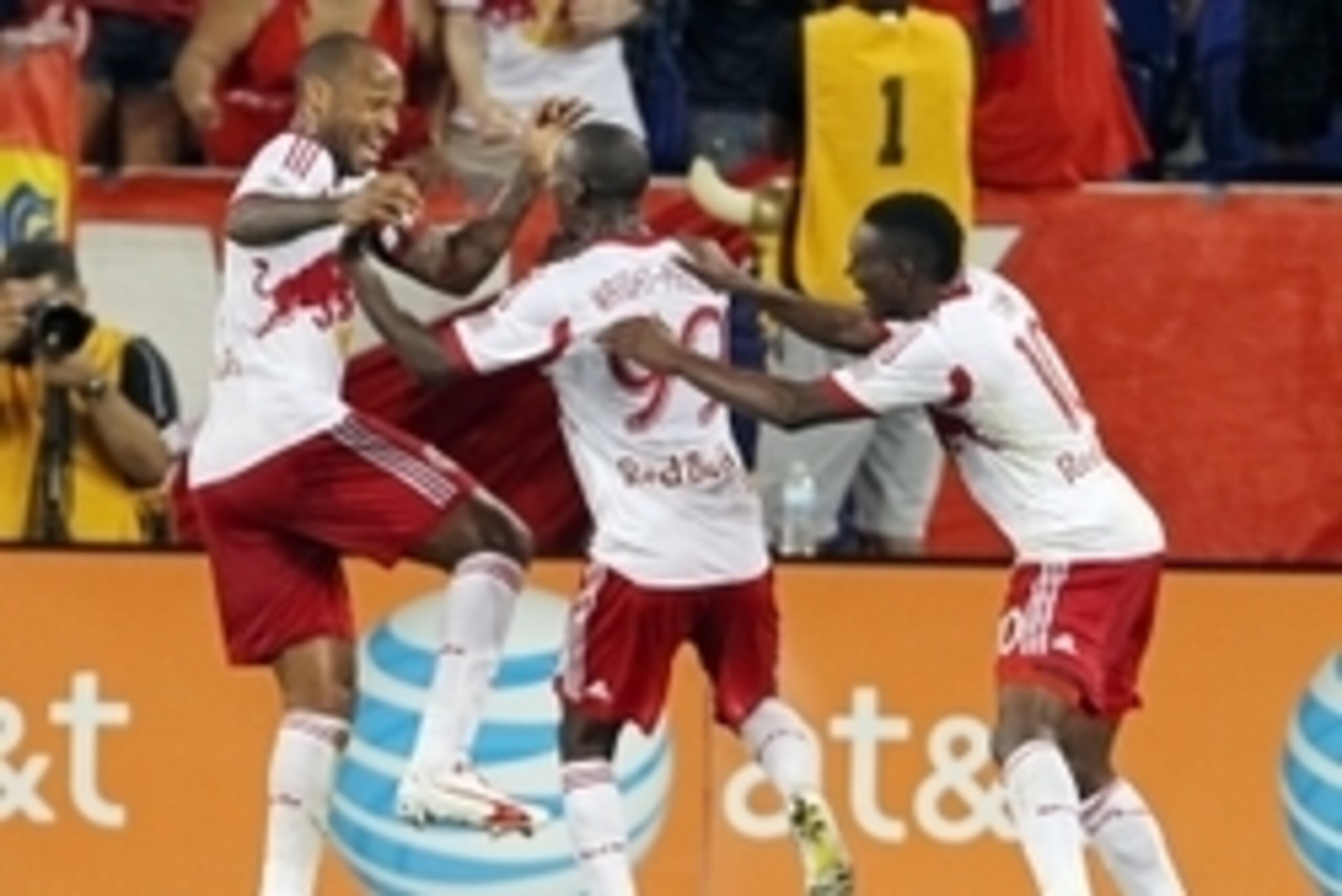 Aug 2, 2014; Harrison, NJ, USA; New York Red Bulls forward Bradley Wright-Phillips (99) celebrates scoring a goal with midfielder Lloyd Sam (10) and forward Thierry Henry (14) against the New England Revolution during the second half at Red Bull Arena. Th