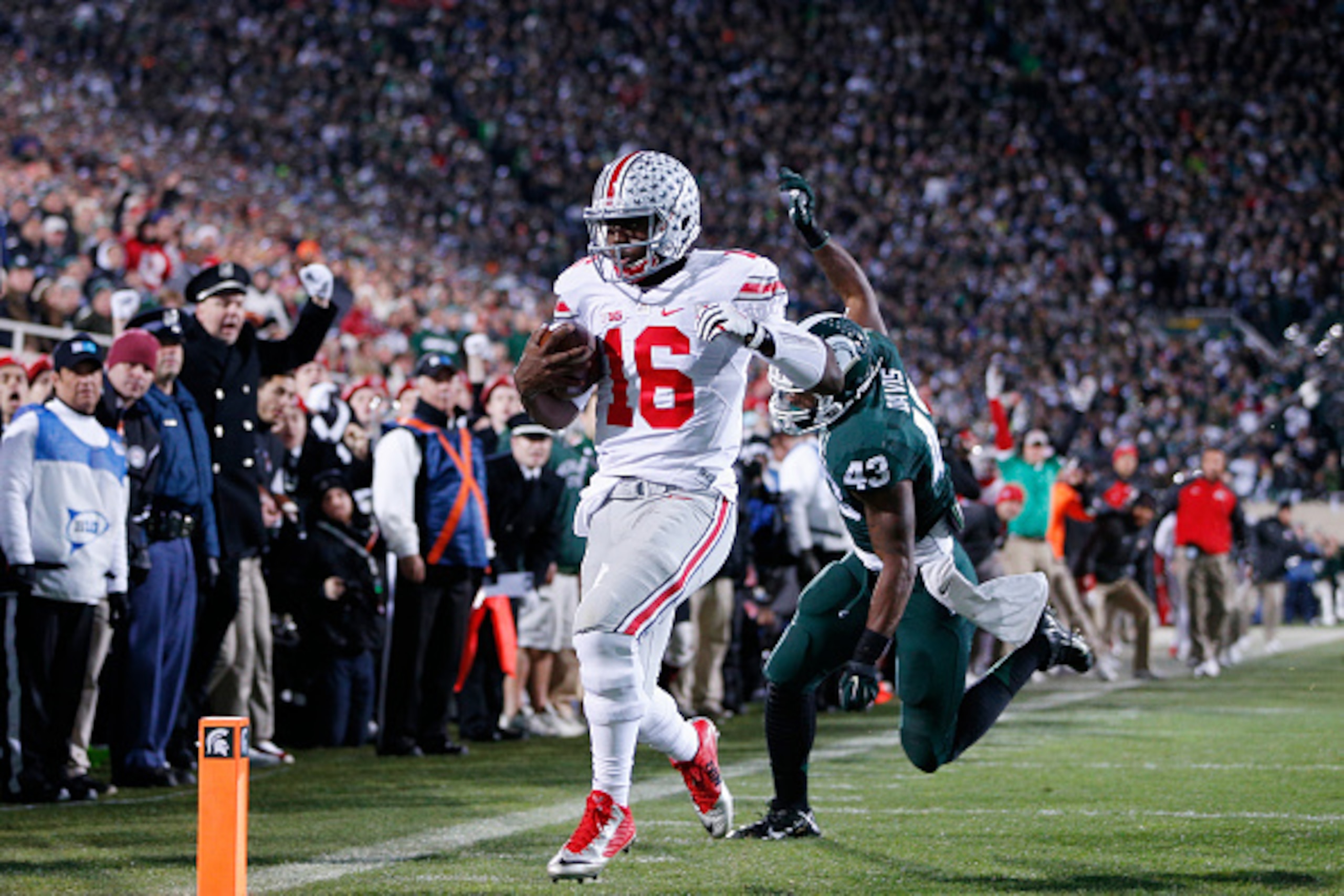 EAST LANSING, MI - NOVEMBER 8: J.T. Barrett #16 of the Ohio State Buckeyes runs for a five-yard touchdown in the first quarter of the game against the Michigan State Spartans at Spartan Stadium on November 8, 2014 in East Lansing, Michigan. (Photo by Joe 
