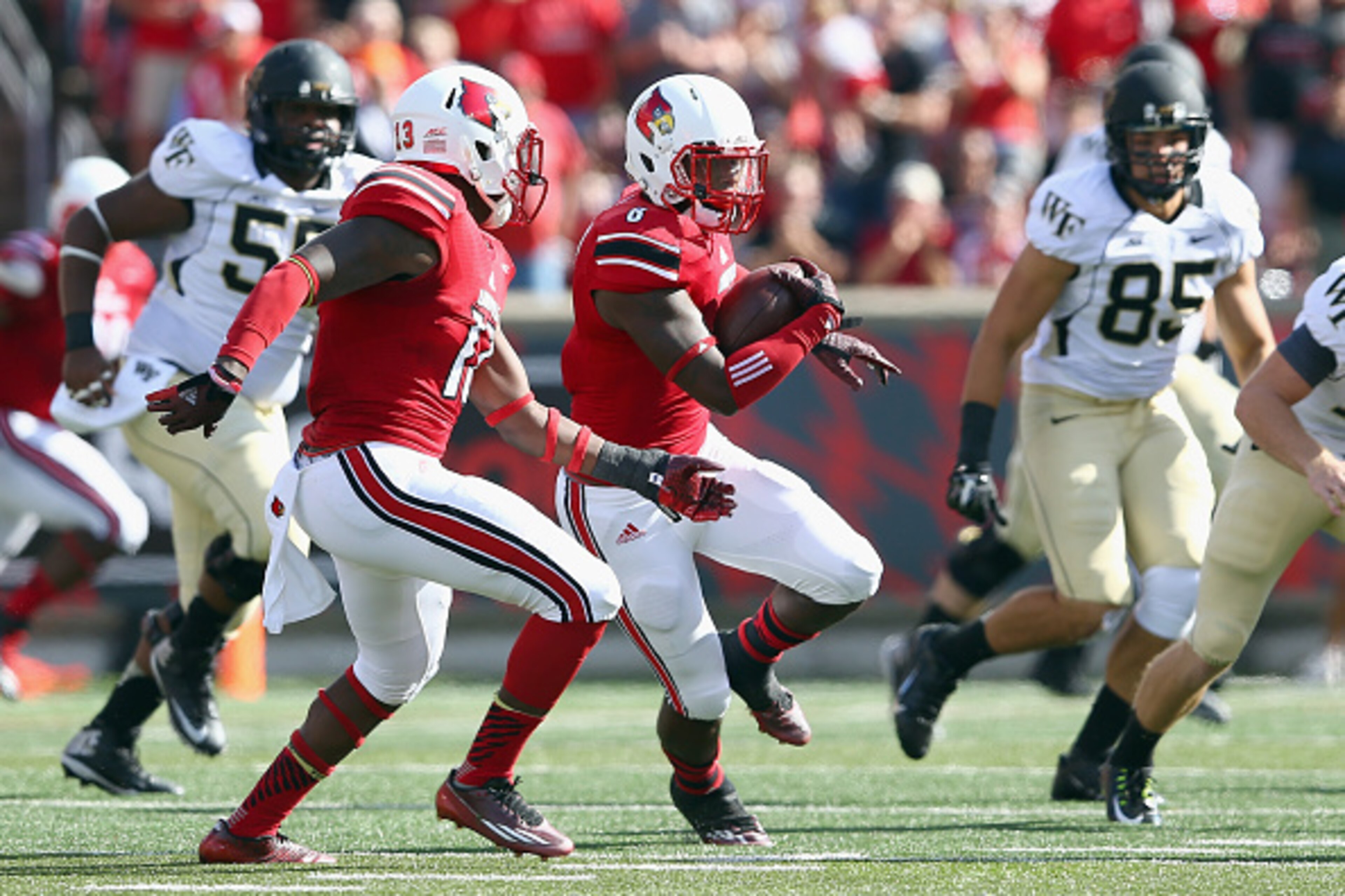 LOUISVILLE, KY - SEPTEMBER 27:  Gerod Holliman #8 of the Louisville Cardinals runs with the ball after intercepting a pass during the game against the Wake Forest Demon Deacons at Papa John's Cardinal Stadium on September 27, 2014 in Louisville, Kentucky.