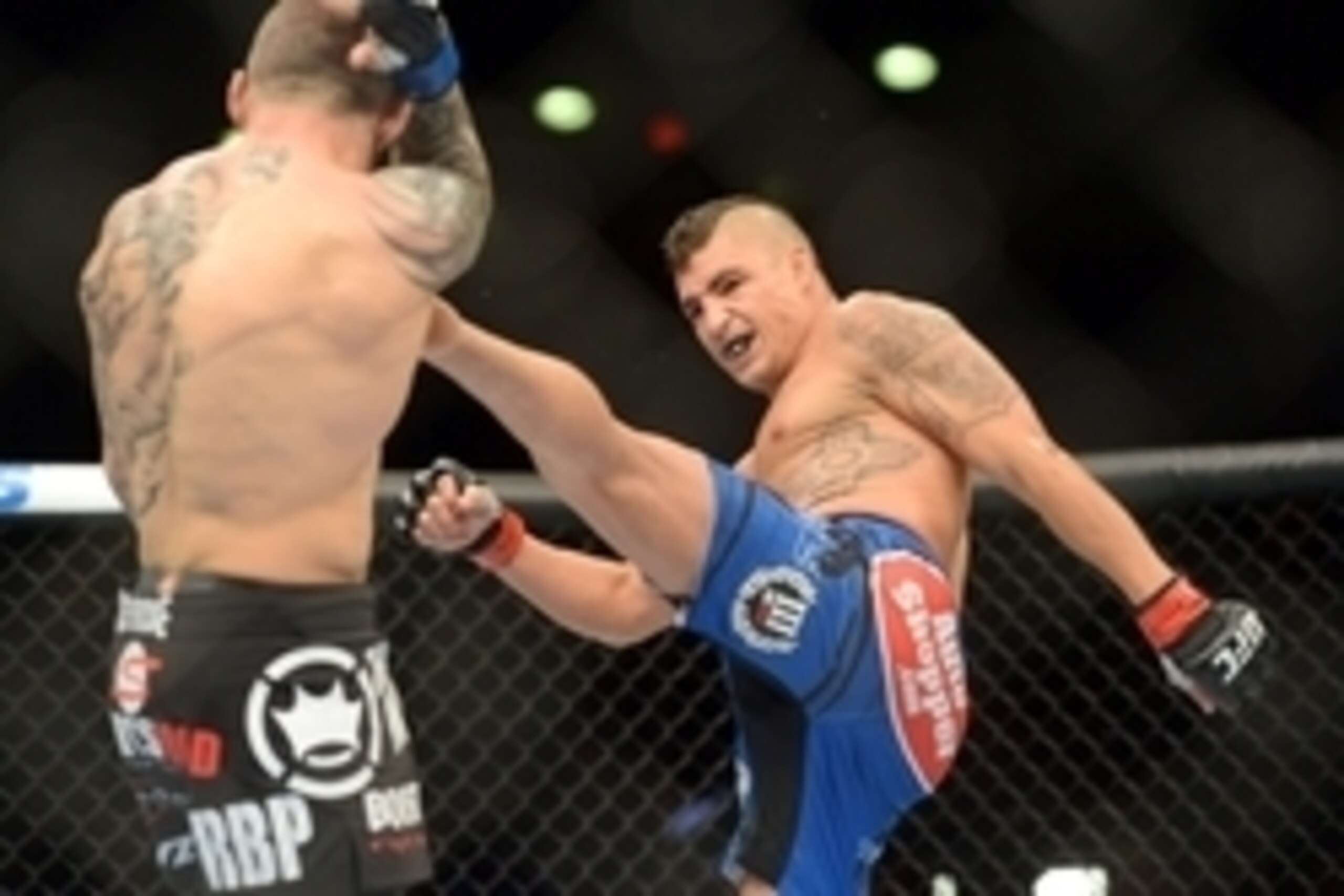Jun 7, 2014; Albuquerque, NM, USA; Diego Sanchez (red) and Ross Pearson (blue) fight during their lightweight bout during UFC Fight Night 42 at Tingley Coliseum. Sanchez won via split decision. Mandatory Credit: Joe Camporeale-USA TODAY Sports