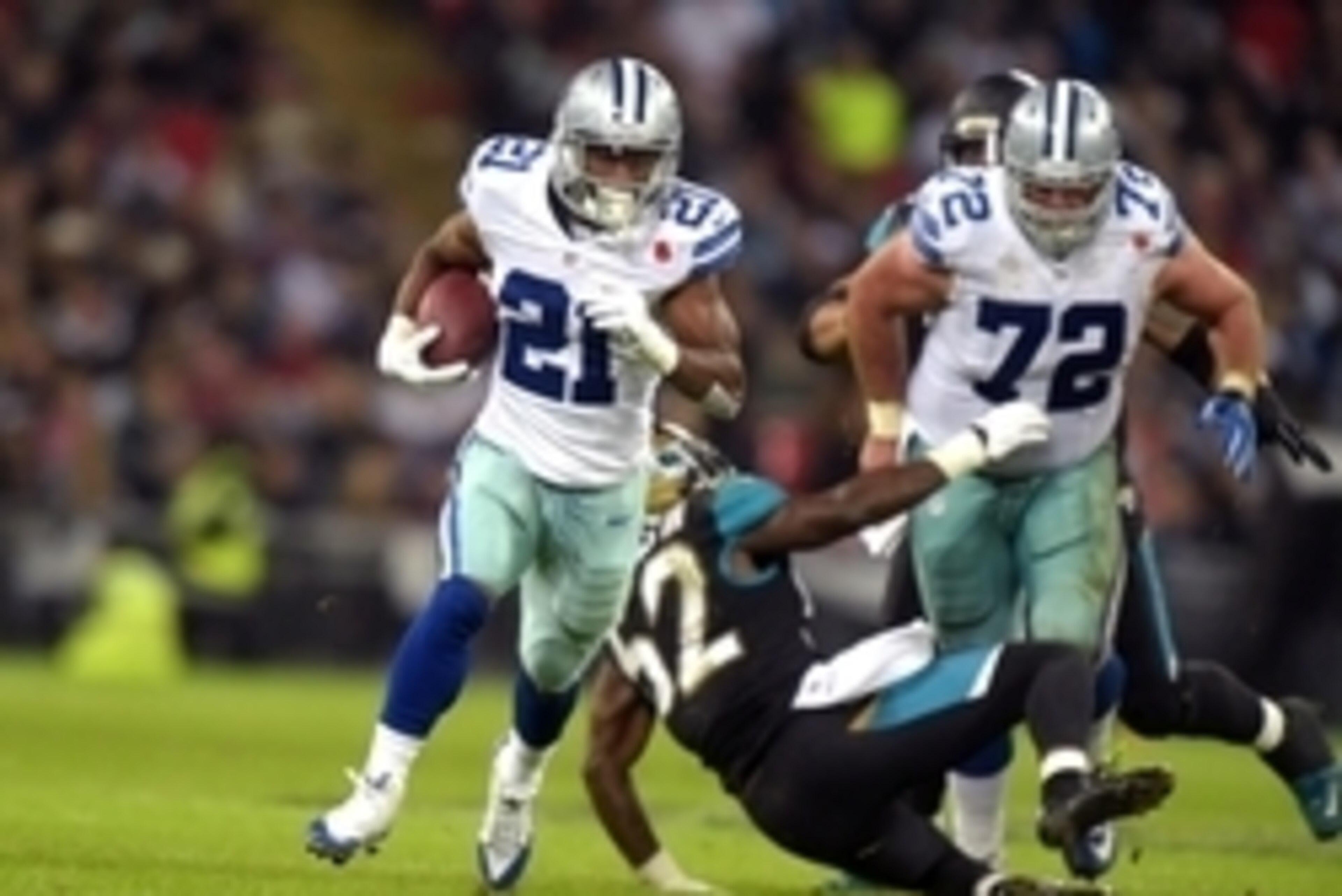 Nov 9, 2014; London, UNITED KINGDOM; Dallas Cowboys running back Joseph Randle (21) scores on a 40-yard touchdown run against the Jacksonville Jaguars in the NFL International Series game at Wembley Stadium. Mandatory Credit: Kirby Lee-USA TODAY Sports