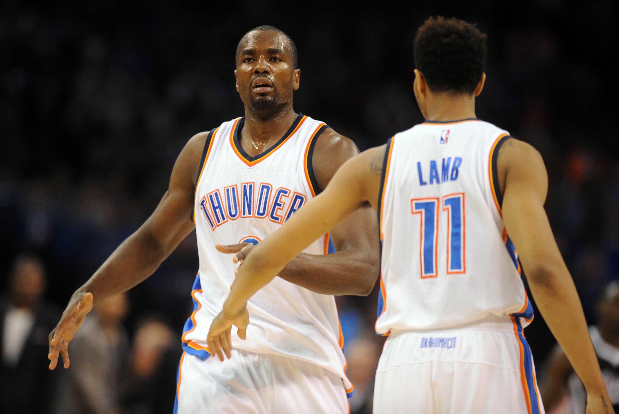 Nov 9, 2014; Oklahoma City, OK, USA; Oklahoma City Thunder forward Serge Ibaka (9) is congratulated by Oklahoma City Thunder guard Jeremy Lamb (11) after a dunk against the Sacramento Kings during the second quarter at Chesapeake Energy Arena. Mandatory C