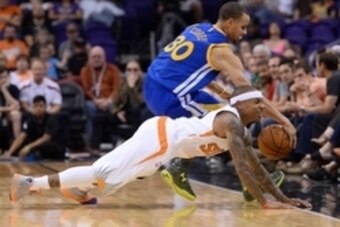 Nov 9, 2014; Phoenix, AZ, USA; Golden State Warriors guard Stephen Curry (30) fouls Phoenix Suns guard Isaiah Thomas (3) during the second half at US Airways Center. The Suns won 107-95. Mandatory Credit: Joe Camporeale-USA TODAY Sports