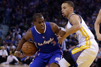 OAKLAND, CA - NOVEMBER 05:  Chris Paul #3 of the Los Angeles Clippers drives past Stephen Curry #30 of the Golden State Warriors at ORACLE Arena on November 5, 2014 in Oakland, California. NOTE TO USER: User expressly acknowledges and agrees that, by down