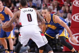PORTLAND, OR - APRIL 13:  Stephen Curry #30 of the Golden State Warriors defends against the Portland Trail Blazers on April 13, 2014 at the Moda Center Arena in Portland, Oregon. NOTE TO USER: User expressly acknowledges and agrees that, by downloading a