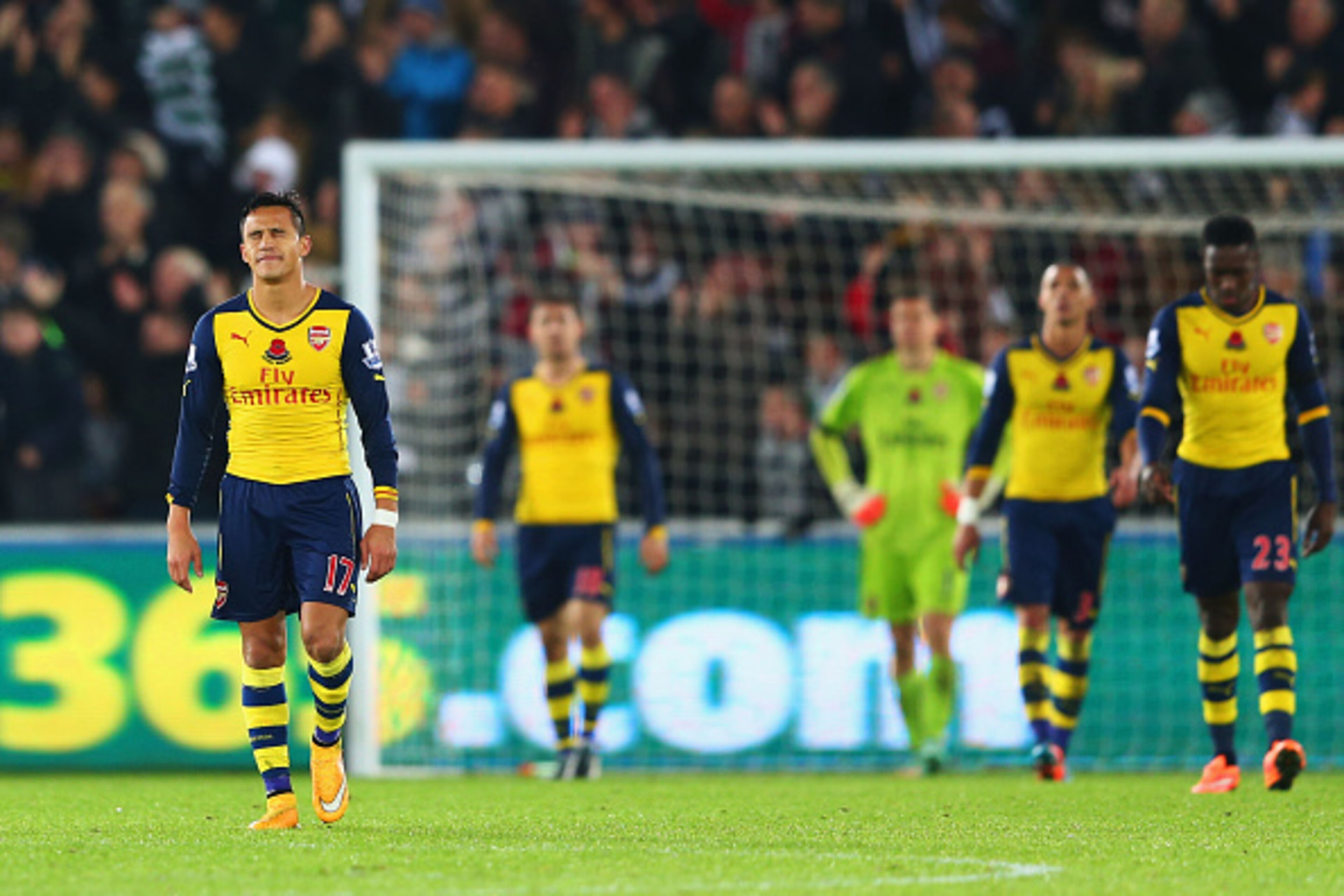 SWANSEA, WALES - NOVEMBER 09:  Alexis Sanchez of Arsenal (L) and team mates look dejected as they concede a goal during the Barclays Premier League match between Swansea City and Arsenal at Liberty Stadium on November 9, 2014 in Swansea, Wales.  (Photo by